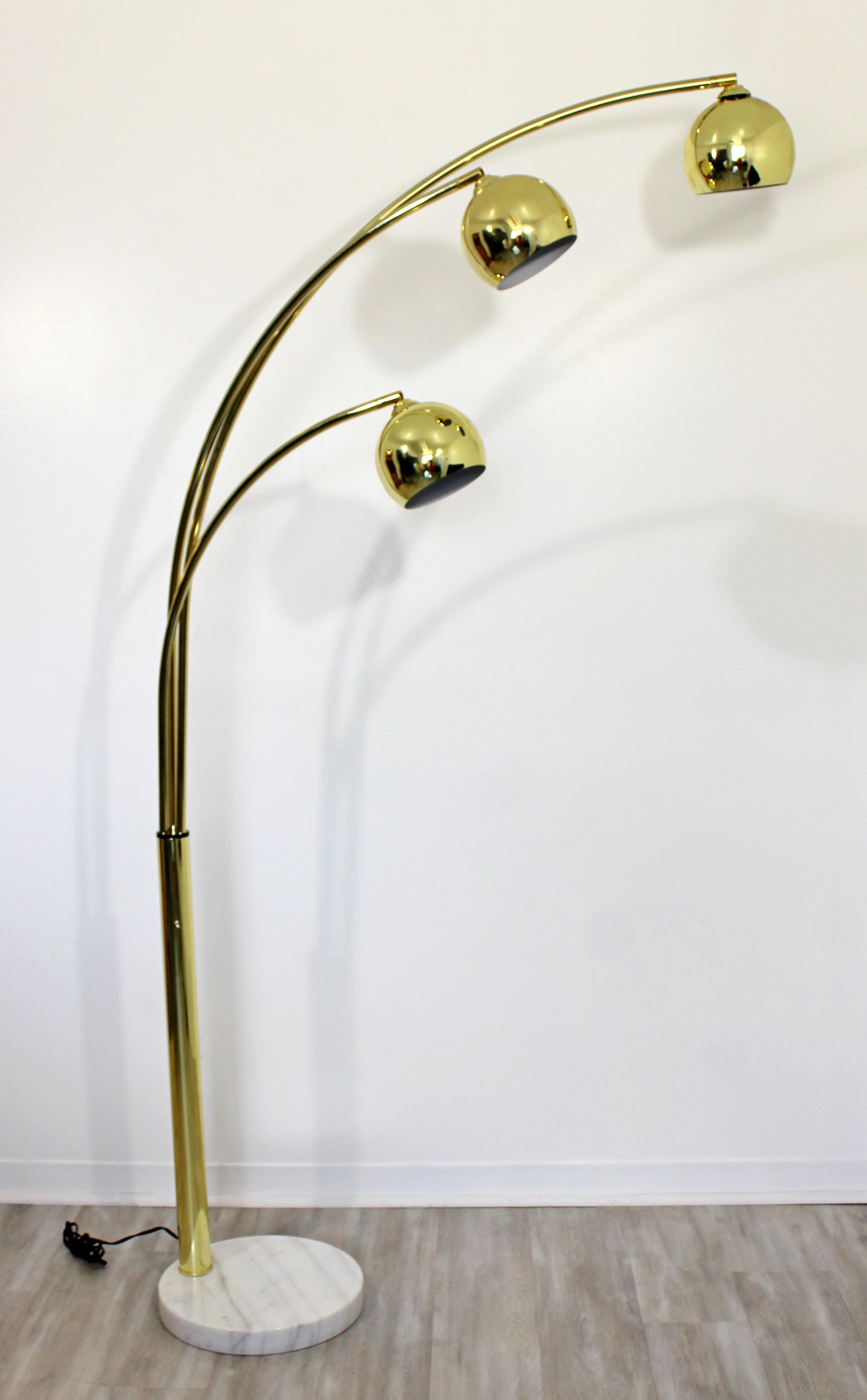 For your consideration is a beautiful, Italian, three articulating arm, brass floor lamp, on a white marble base, circa 1970s. In excellent vintage condition. The dimensions are as much as 74