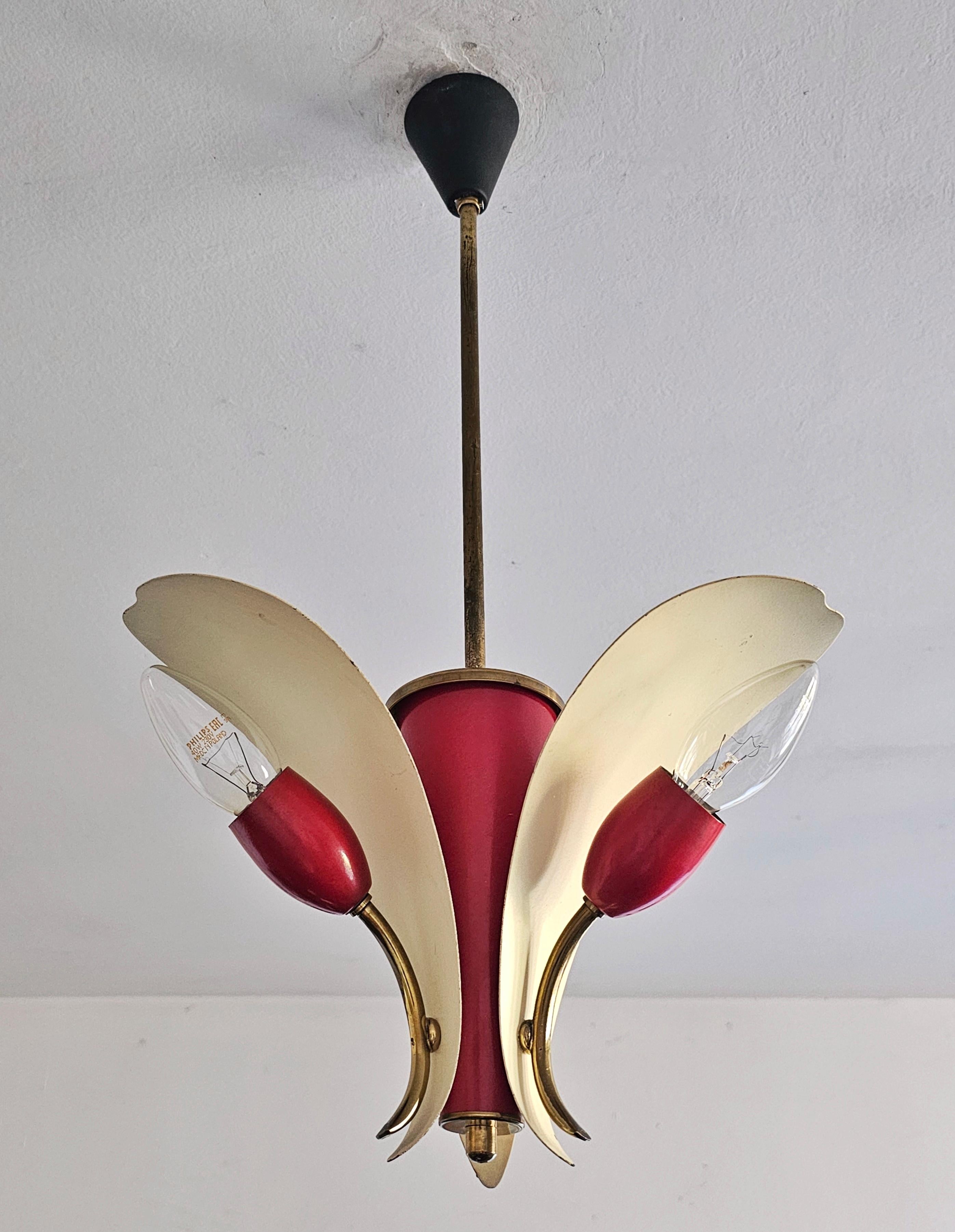 In this listing you will find a very rare Mid Century Modern pendant light or small chandelier designed by Fog and Morup. It features beautiful, elegant design that reminds you of a flower in combination of red and cream, with brass fixture. Made in