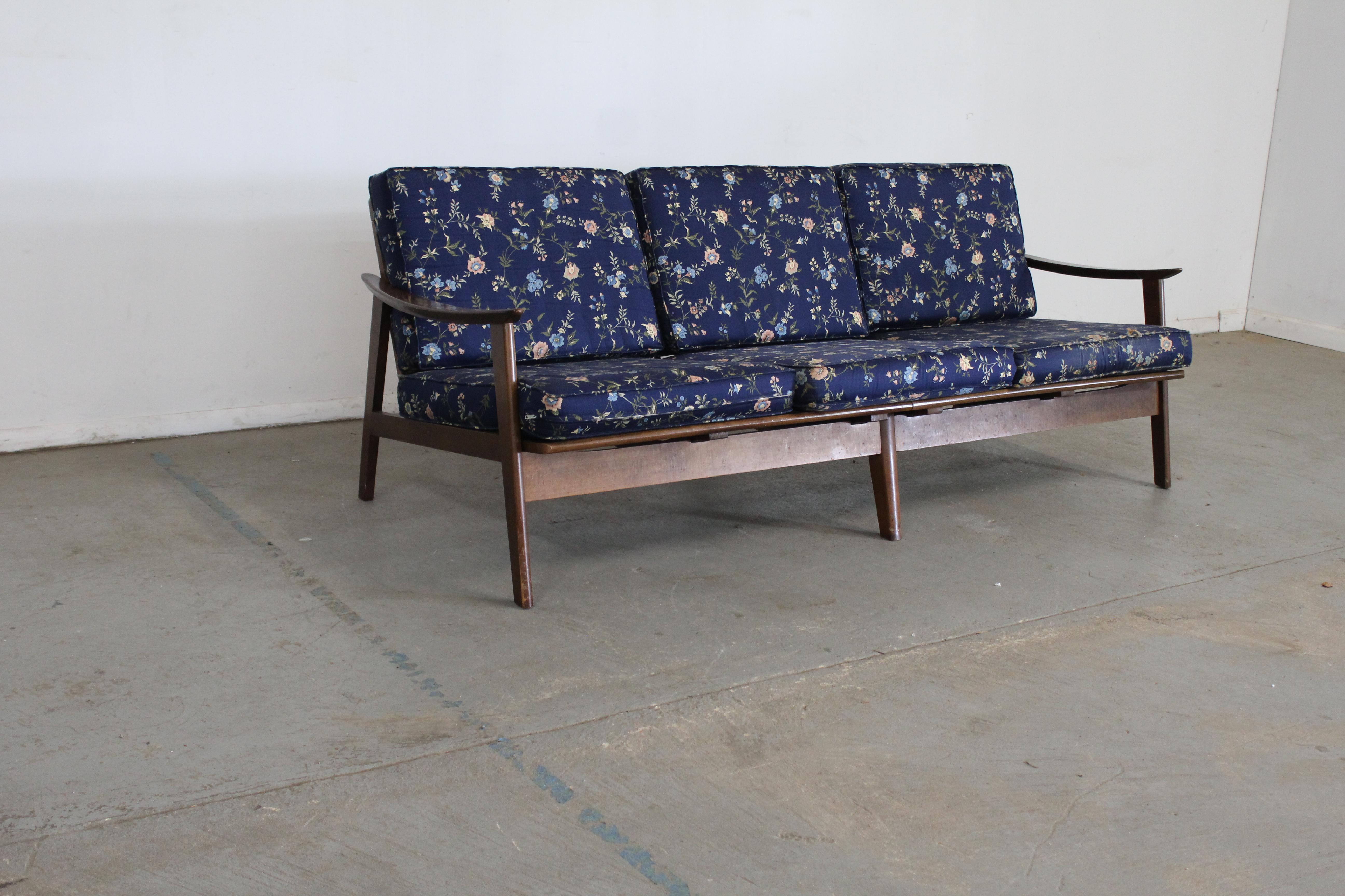 Mid-Century Modern 3 Cushion Open Arm Walnut Sofa
Offered is a unrestored original mid-century modern sofa.  The sofa features a wonderful and stylish Walnut frame.  The splayed legs legs are accentuated by the Banana Style arms. The piece is design