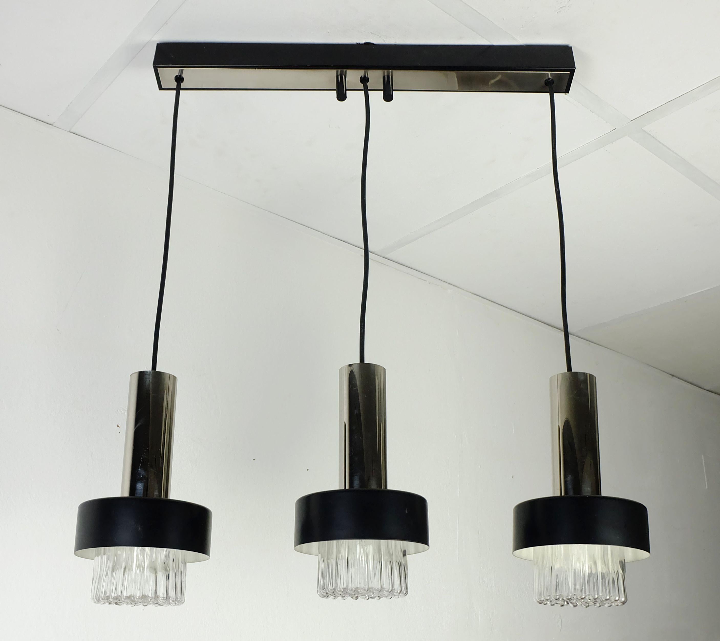 Very beautiful and elegant 3-light pendant lamp manufactured in the 1960s. 3 bubble glass shades with black metal covers and chrome tubes on top. Holds 3 E14 bulbs. 

Dimensions: overall length 27 1/10
