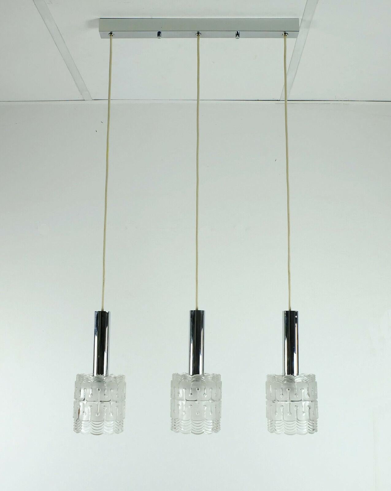 Very beautiful and elegant 3-Light pendant lamp manufactured by Hillebrand in the 1960s. 3 glass shades with chrome tubes on top. Holds each 1 E14 bulb. (not included)

Very good condition, in full working order. We recommend professional