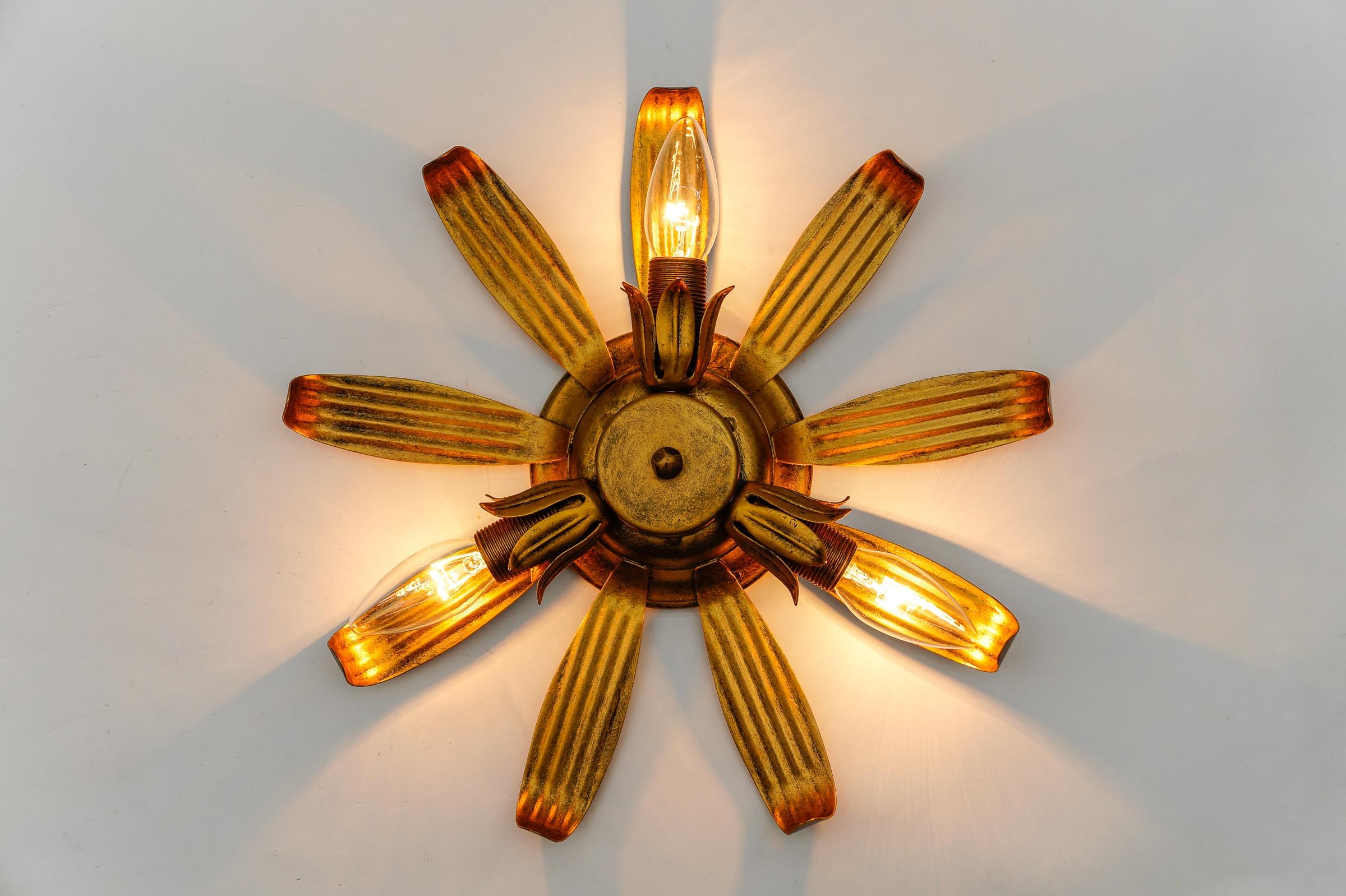 Mid-Century Modern 3-Light Sunburst Lamp, 1960 Italy

Rare and elegant midcentury ceiling lamp, 1960s. Executed in metal.

The lamp is executed with 3 x E14 Edison screw fit bulbs. It is wired and in working condition. It runs both on 110 / 230