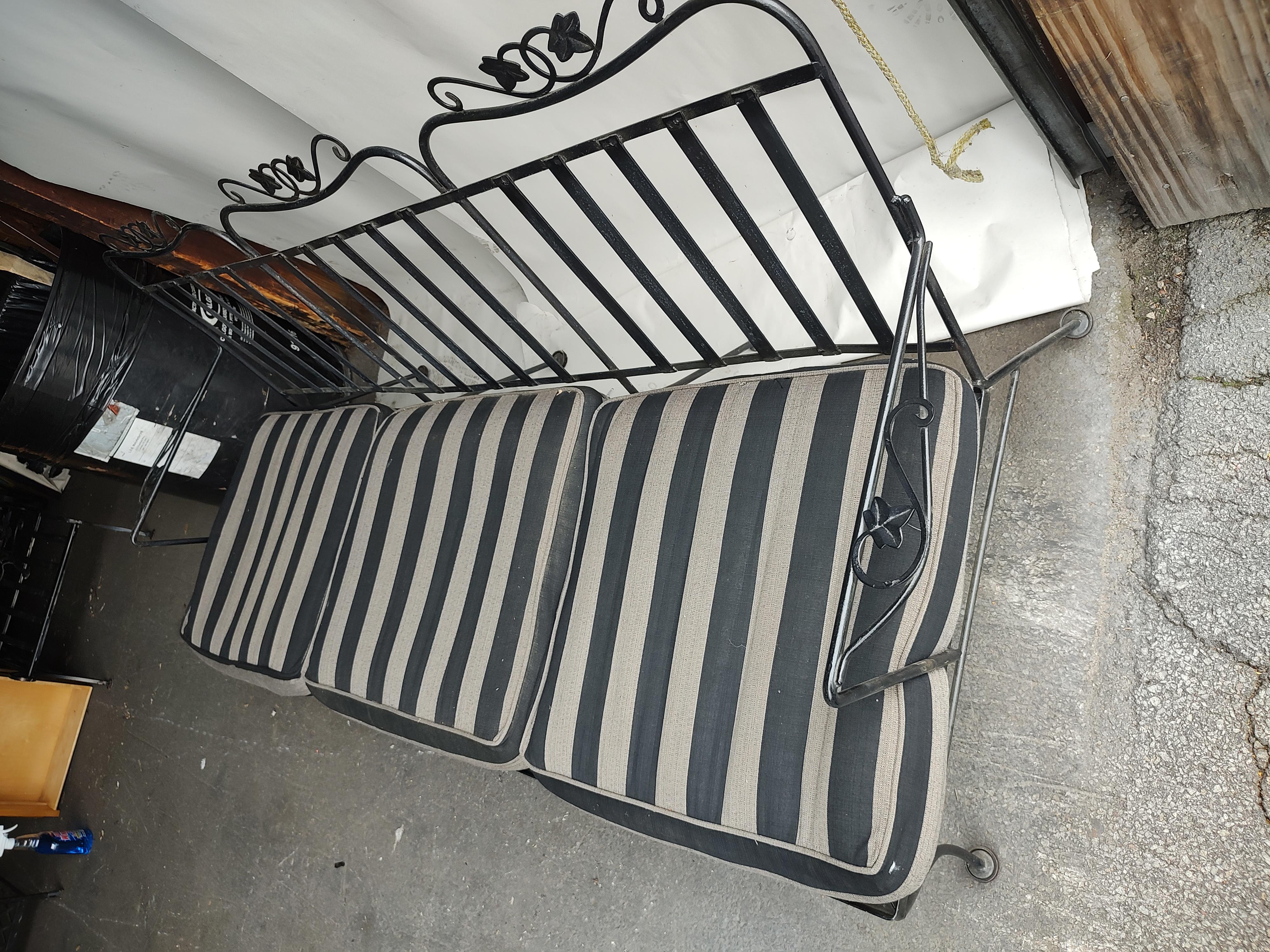 Fabulous Salterini iron sofa with full cushions, 6 striped outdoor fabric with plenty of foam in good condition. Could probably use a trip thru the washer. Iron is in excellent vintage condition with minimal wear and lots of paint. Curved back