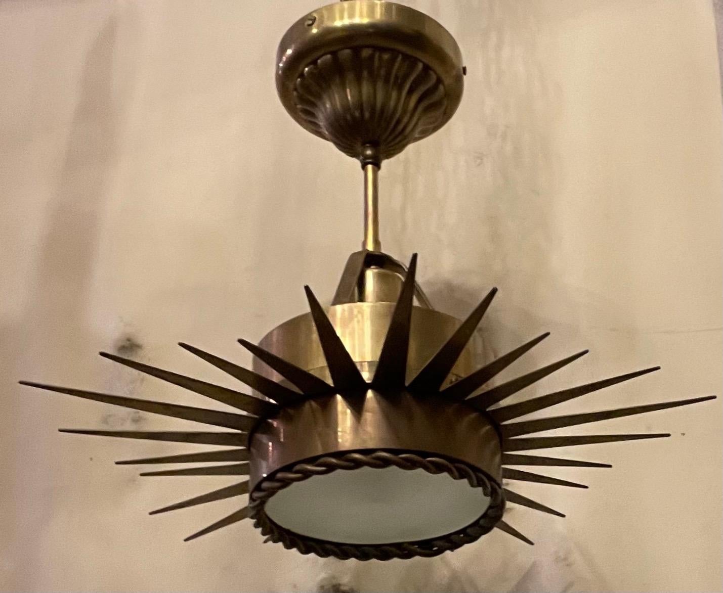 A wonderful semi-flush antiqued brass star form pendent fixture with braided frame housing a frosted glass panel, with a UL listed Edison base taking up to a 60 watt light bulb. Measures: 14
