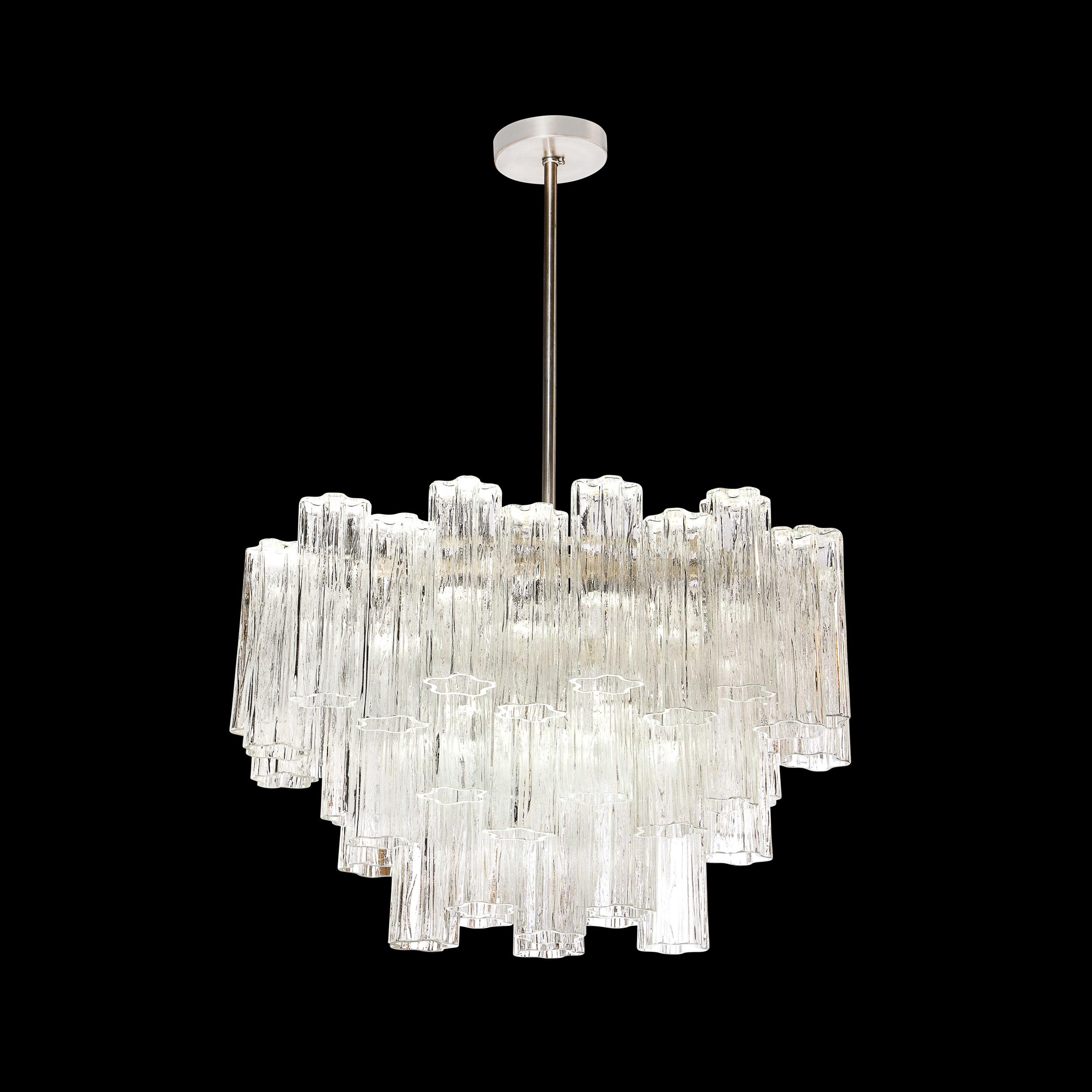 This elegant and graphic Mid-Century Modern chandelier was realized in Murano, Italy- the island off the coast of Murano renowned for centuries for its superlative glass production- circa 1970. It features an racetrack drum form consisting of three