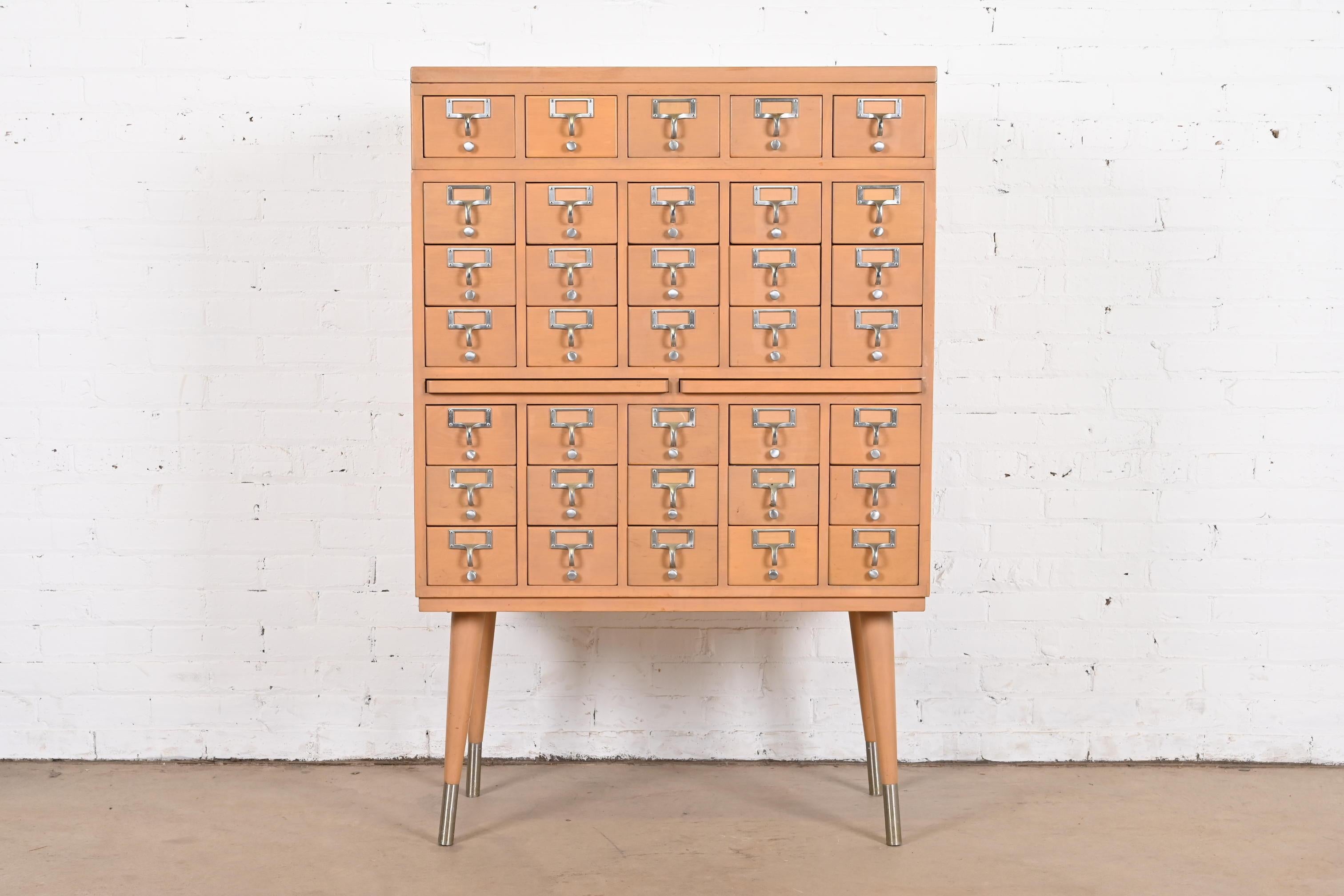 A rare Mid-Century Modern 35-drawer library card catalog cabinet

By John E. Sjöström Co.

USA, Circa 1950s

Maple, with steel hardware.

Measures: 33