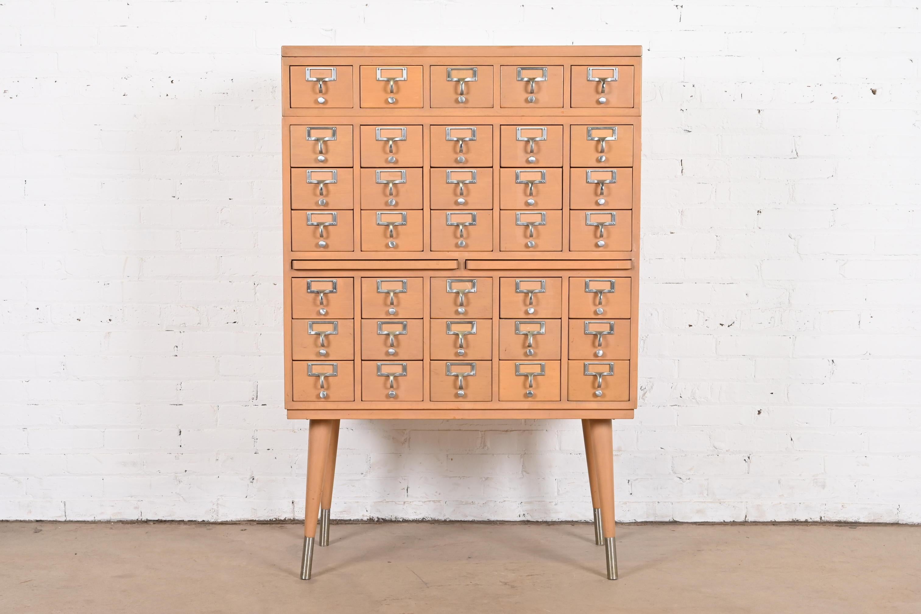 A rare Mid-Century Modern 35-drawer library card catalog cabinet

By John E. Sjöström Co.

USA, Circa 1950s

Maple, with steel hardware.

Measures: 33