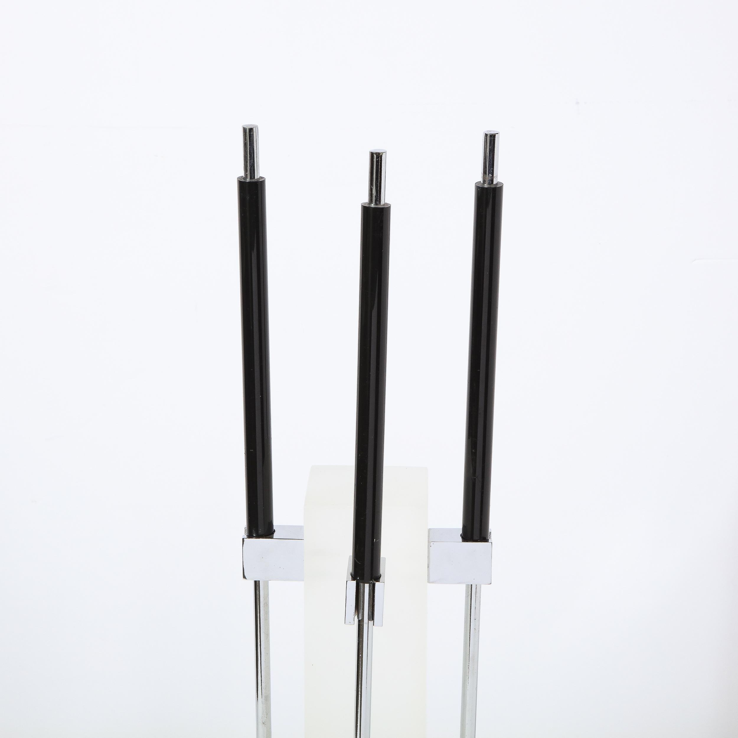 This sophisticated fire tool set was realized by the esteemed American maker Pace Furniture Co. circa 1970. It features a central slender rectangular frosted lucite body sitting atop a rectangular polished chrome base. Three rectangular arms with
