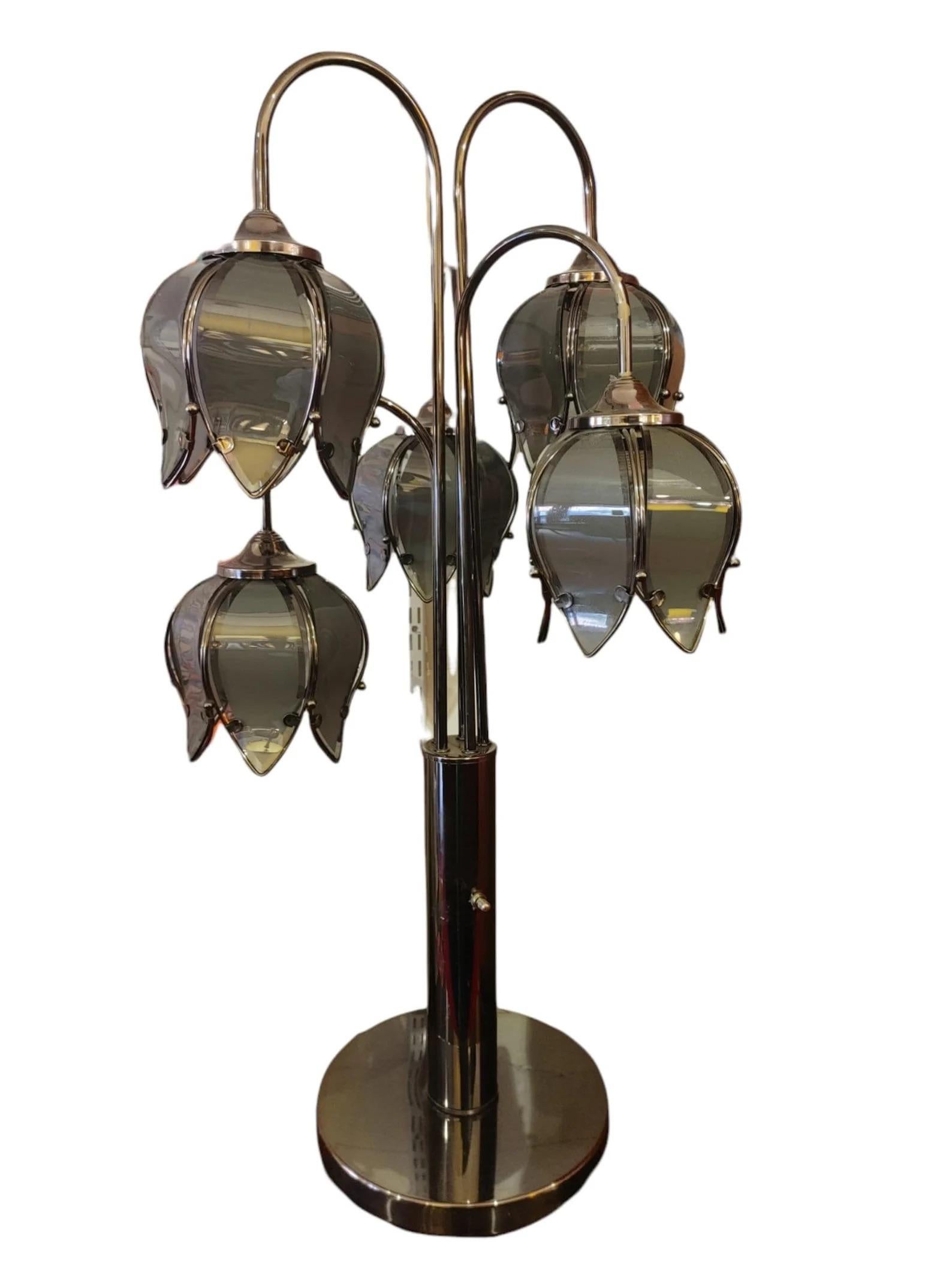Mid-Century Modern 5 Arm Lotus Lamp 1970s
Base and arms are a black polished chrome
Lotus shades are glass petal design in smoky gray and blue hues
Light switch are three-way so that two bulbs light up at each turn and then finally all are lit up