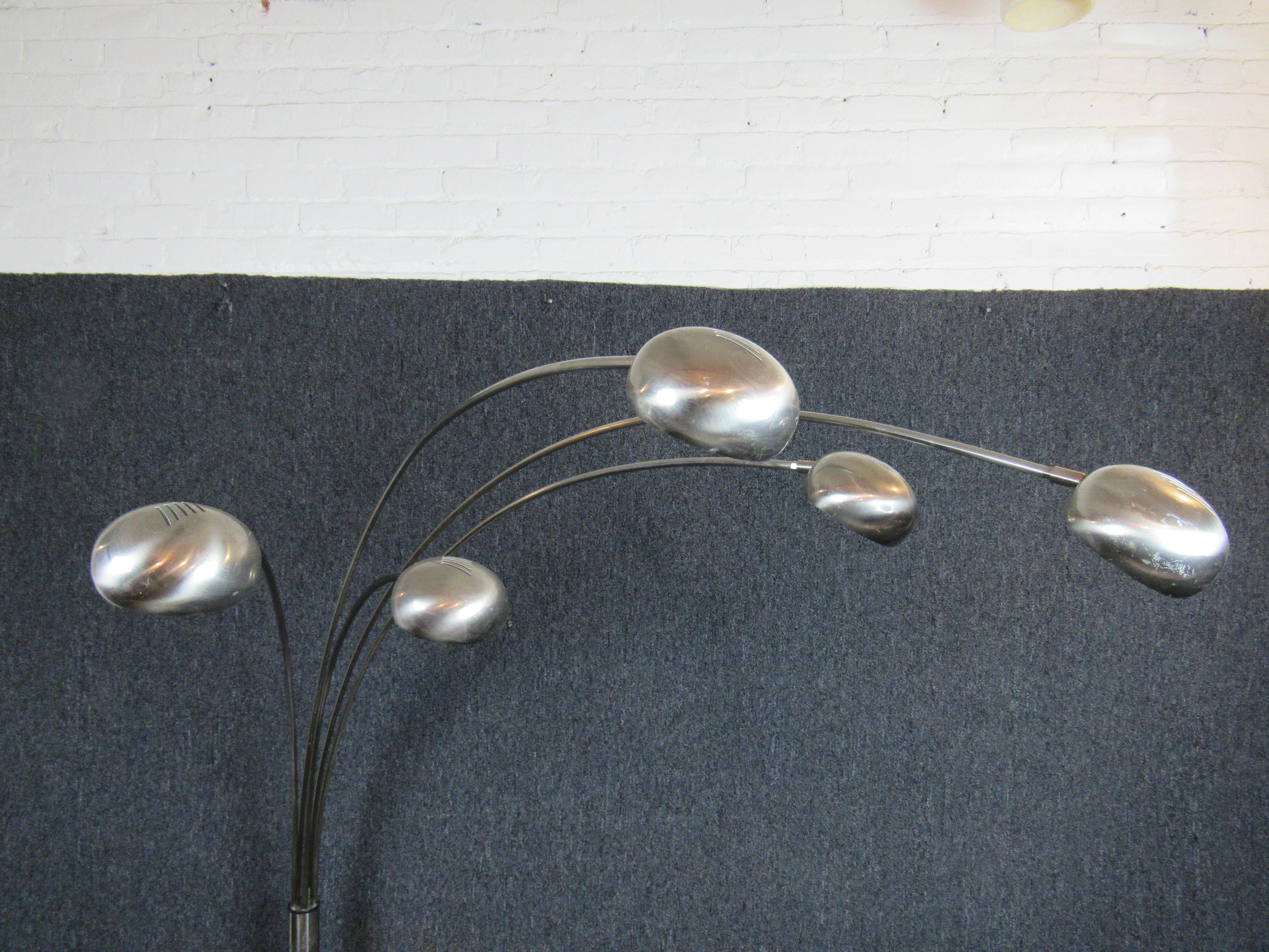 Mid-Century Modern 5 chrome arcs floor lamp with white marble stone base. This arc lamp is very unique in its form offering 5 arcs connected to a base which swivel left to right. This feature allows for the lamp to form and adjust to the space that