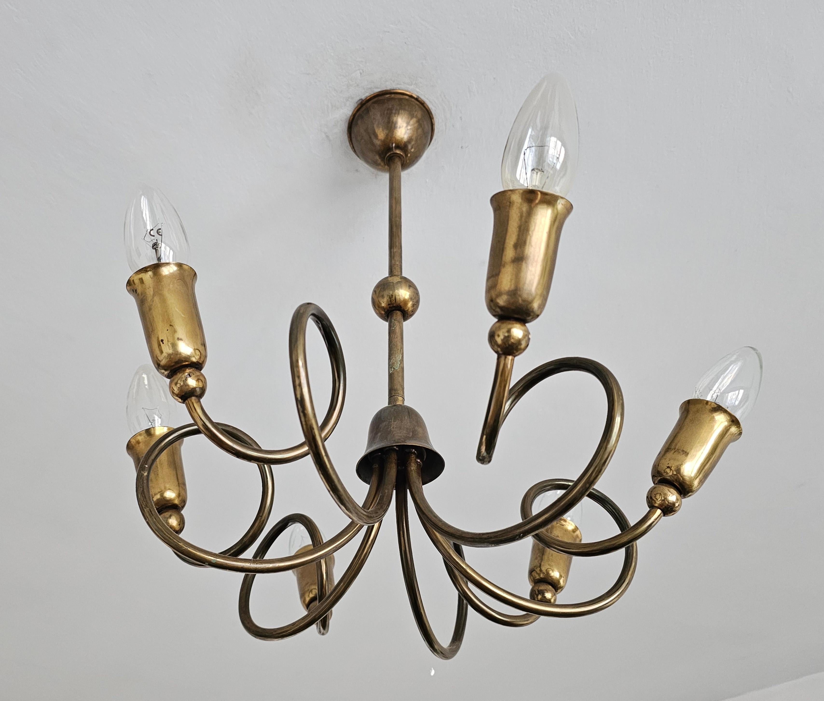 In this listing you will find a very unusual Mid Century Modern 6-Arm Sputnik Chandelier. It features twisted brass arms to which the lights are attached. The chandelier is designed in style of renowned Italian lighting company Stilnovo. Made in