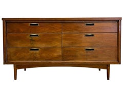 Mid Century Modern 6 Drawer Dresser with Sculpted Base and Brass-Toned Pulls.