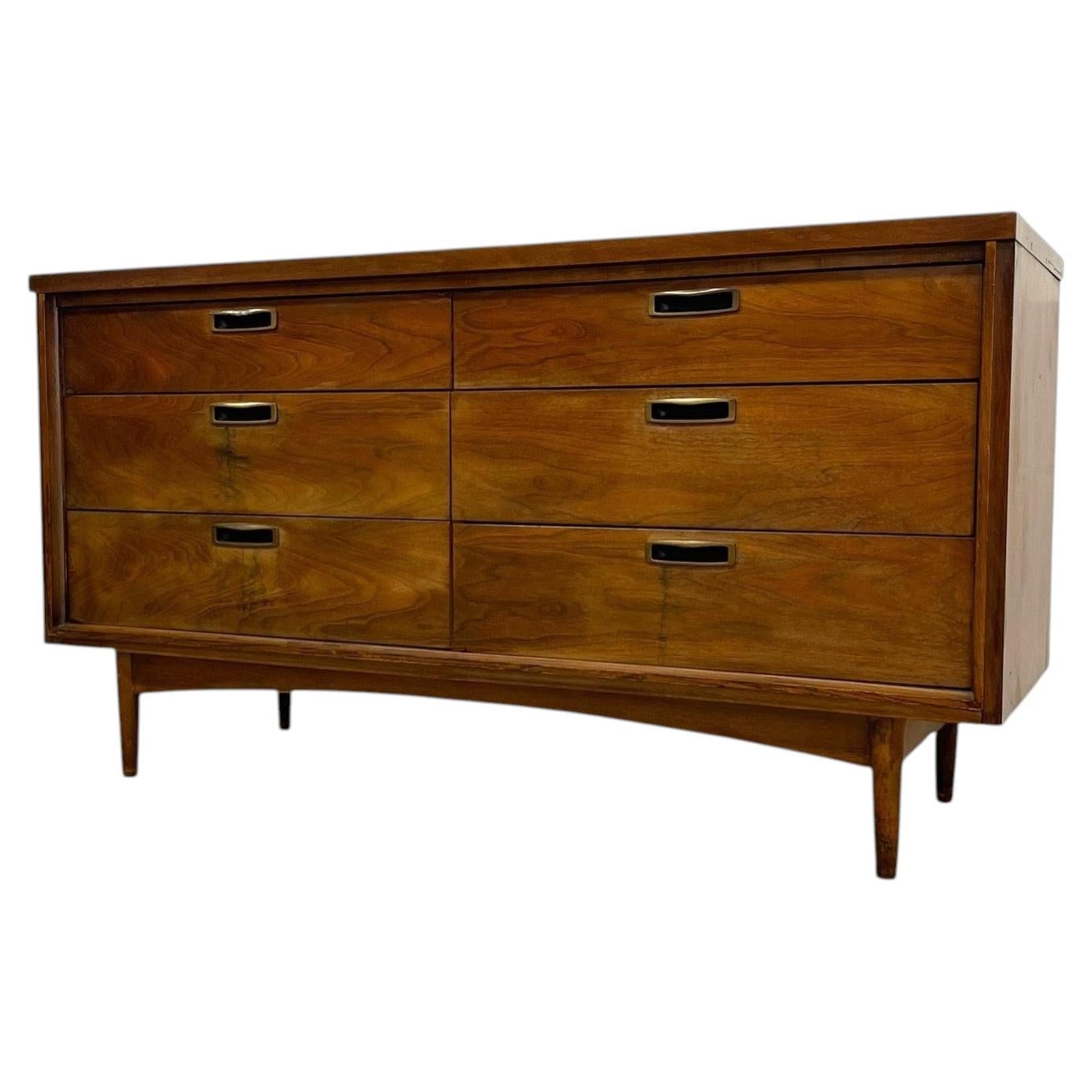 Mid Century Modern 6 Drawer Dresser with Sculpted Base and Brass-Toned Pulls.