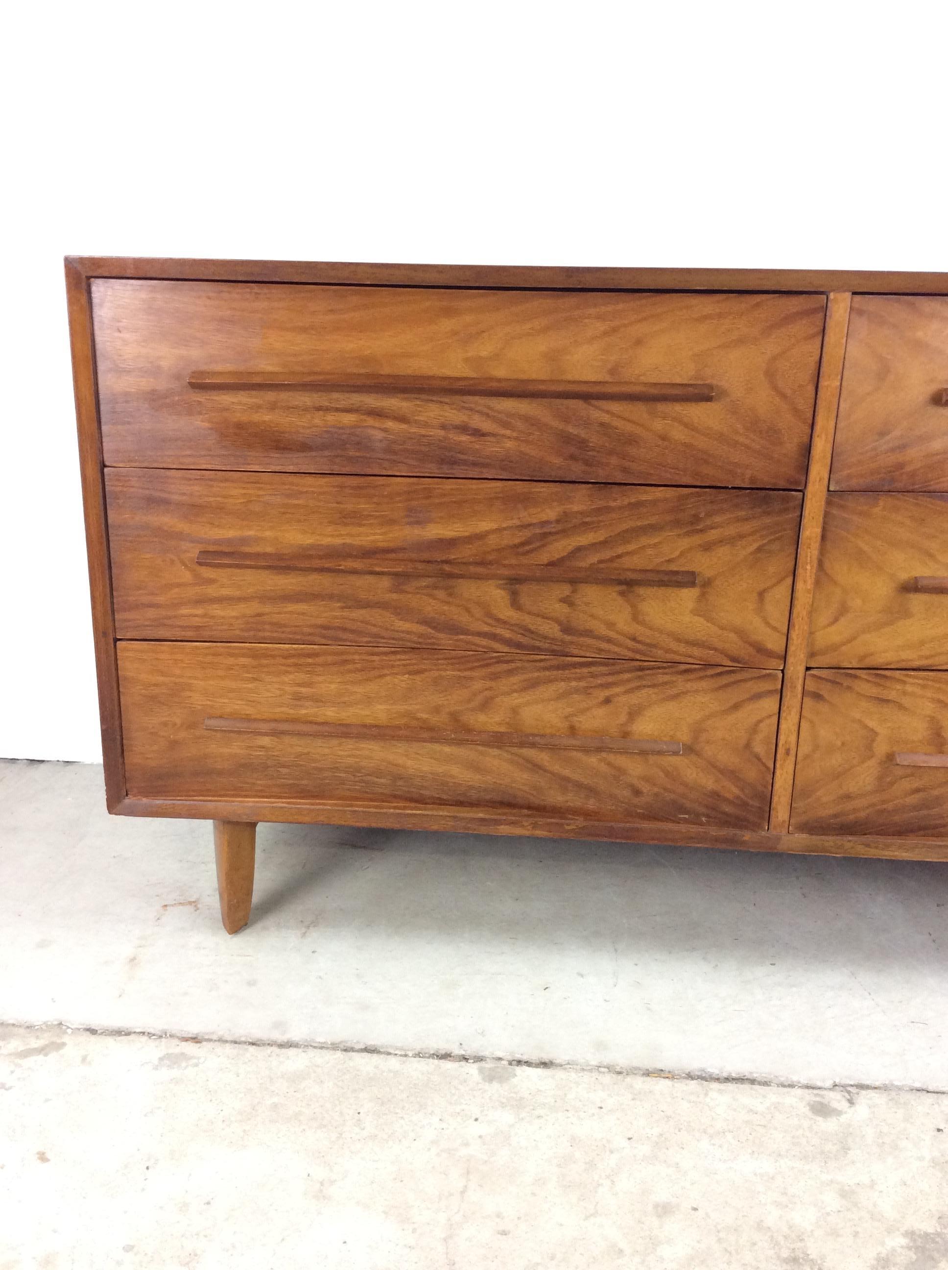 This mid century modern lowboy dresser by Widdicomb features hardwood construction, beautiful walnut veneer with original finish, six dovetail drawers with sculpted wood pulls, and tall tapered legs.

Matching pair of nightstand & complimentary wall
