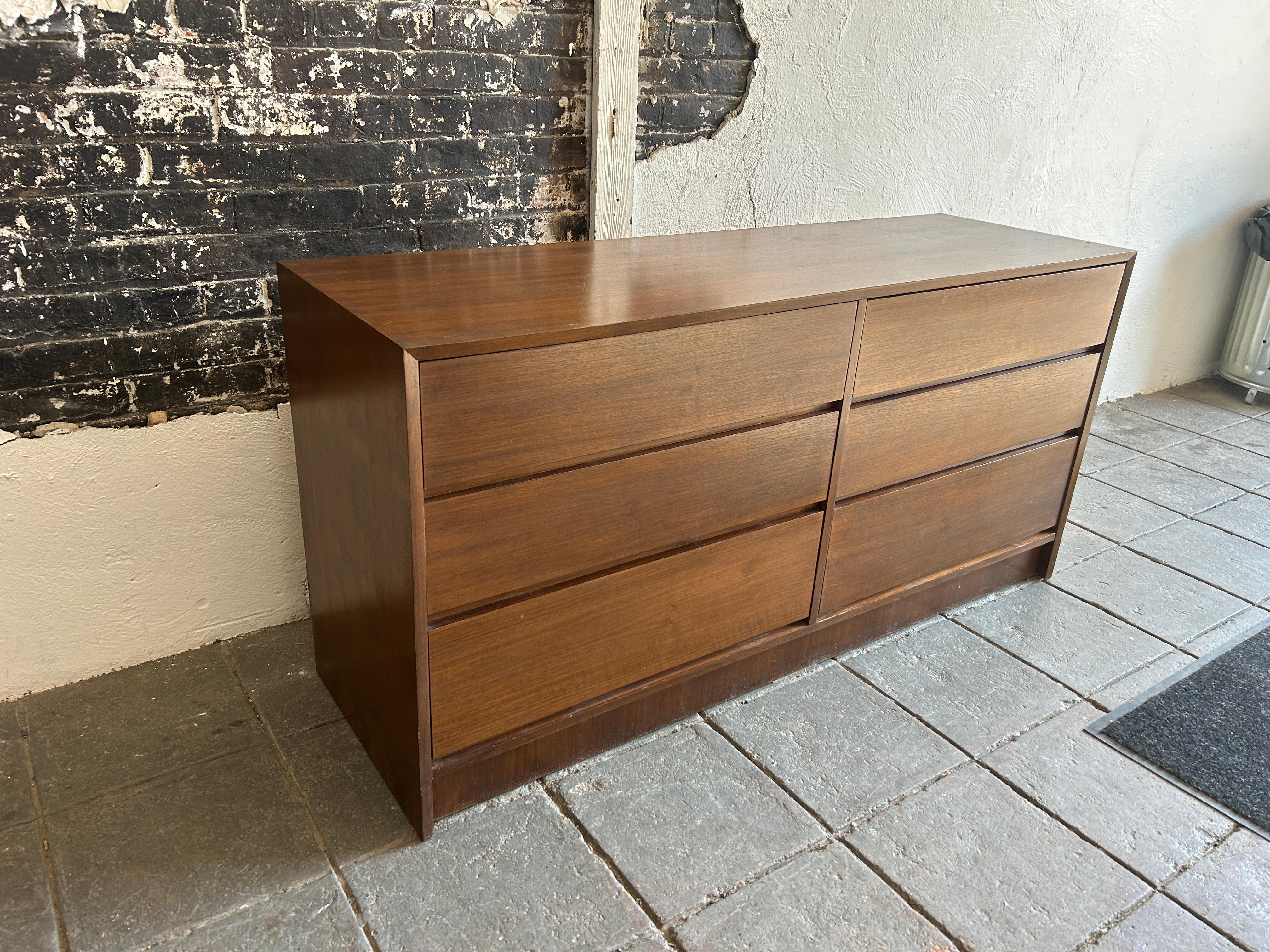 Mid century post modern 6 drawer simple walnut dresser. Simple designed walnut veneer dresser over birch construction. All drawers are solid birch and are very well constructed. Dark brown walnut finish. Very clean inside and out. Made in Poland.