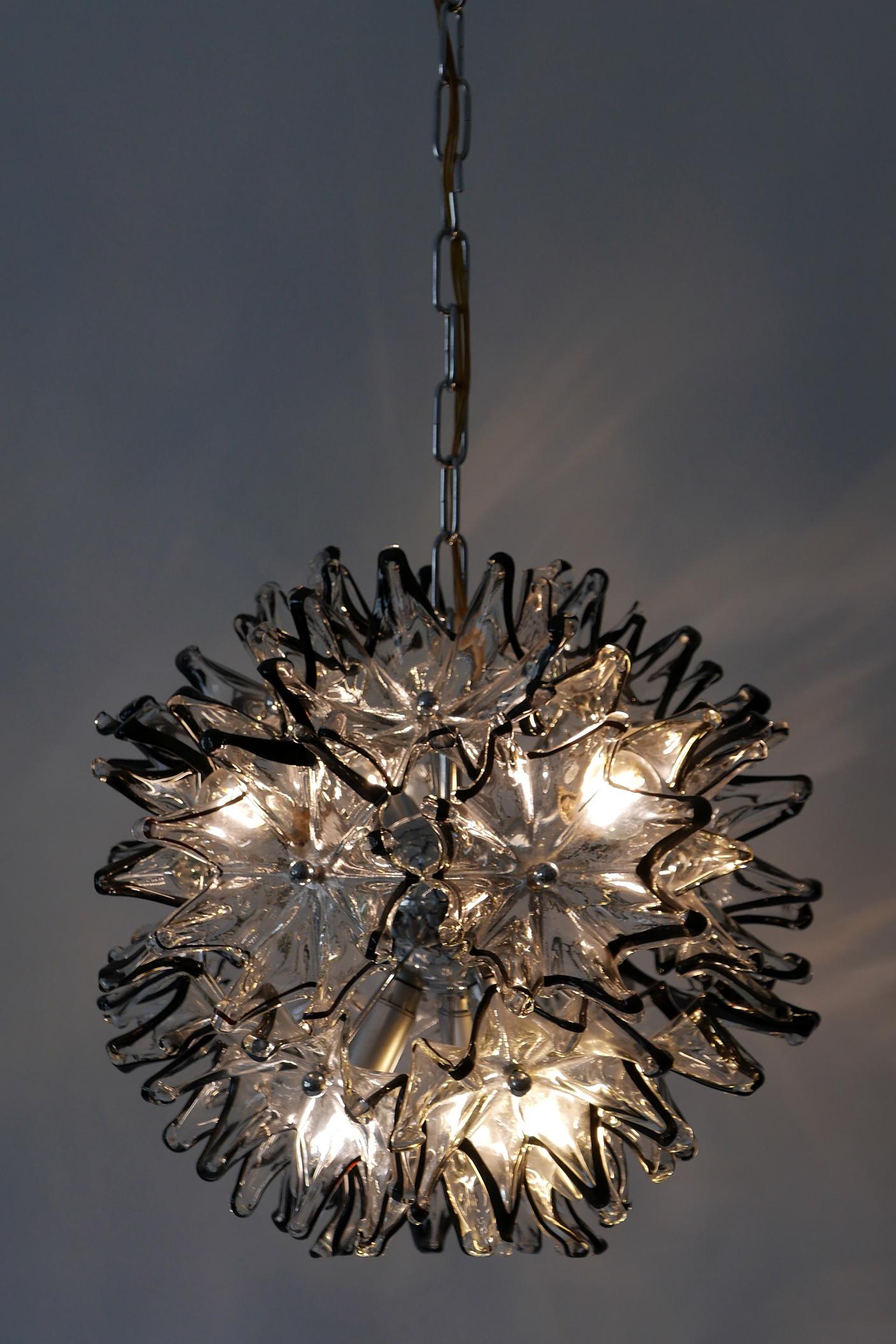 Amazing, highly decorative and elegant Mid-Century Modern 6-flamed Murano glass chandelier or pendant lamp 'Dandelion'. Manufactured probably by VeArt, 1960s in Italy.

Executed in flower shaped Murano Glass elements and chrome-plated steel, the