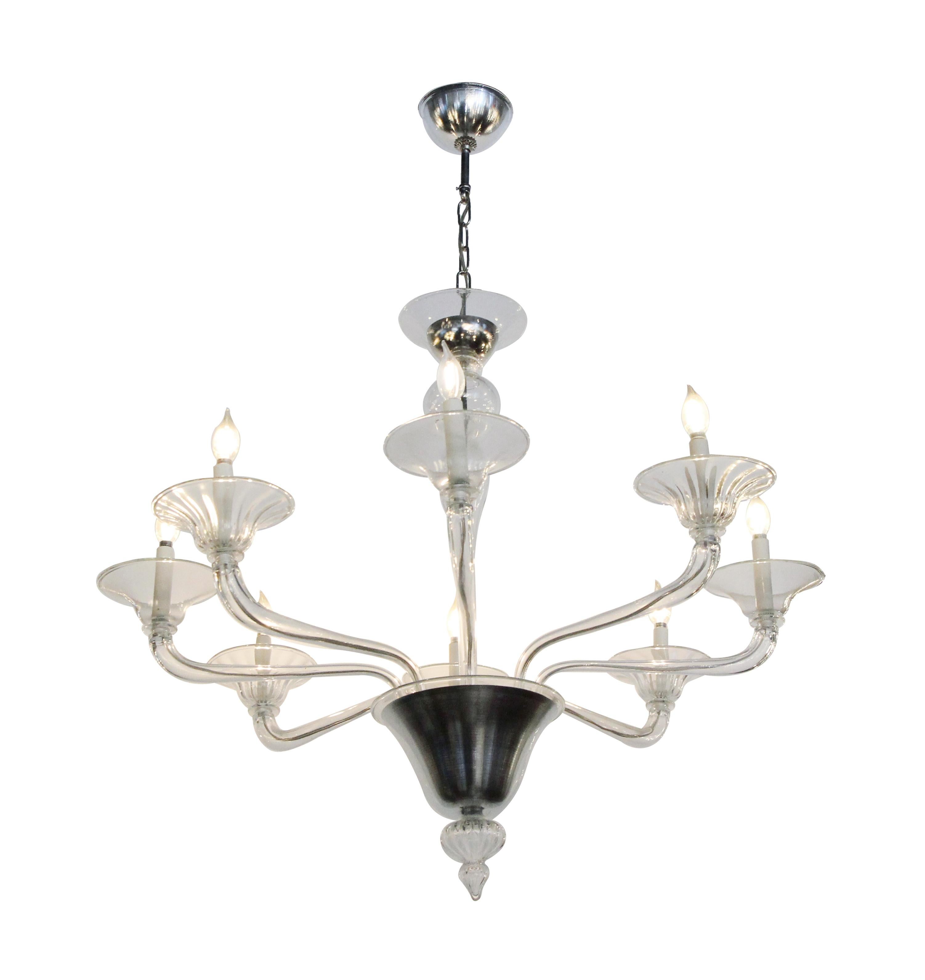 Mid-Century Modern style eight-arm chandelier made of glass and steel with a brushed finish. This can be seen at our 2420 Broadway location on the upper west side in Manhattan.