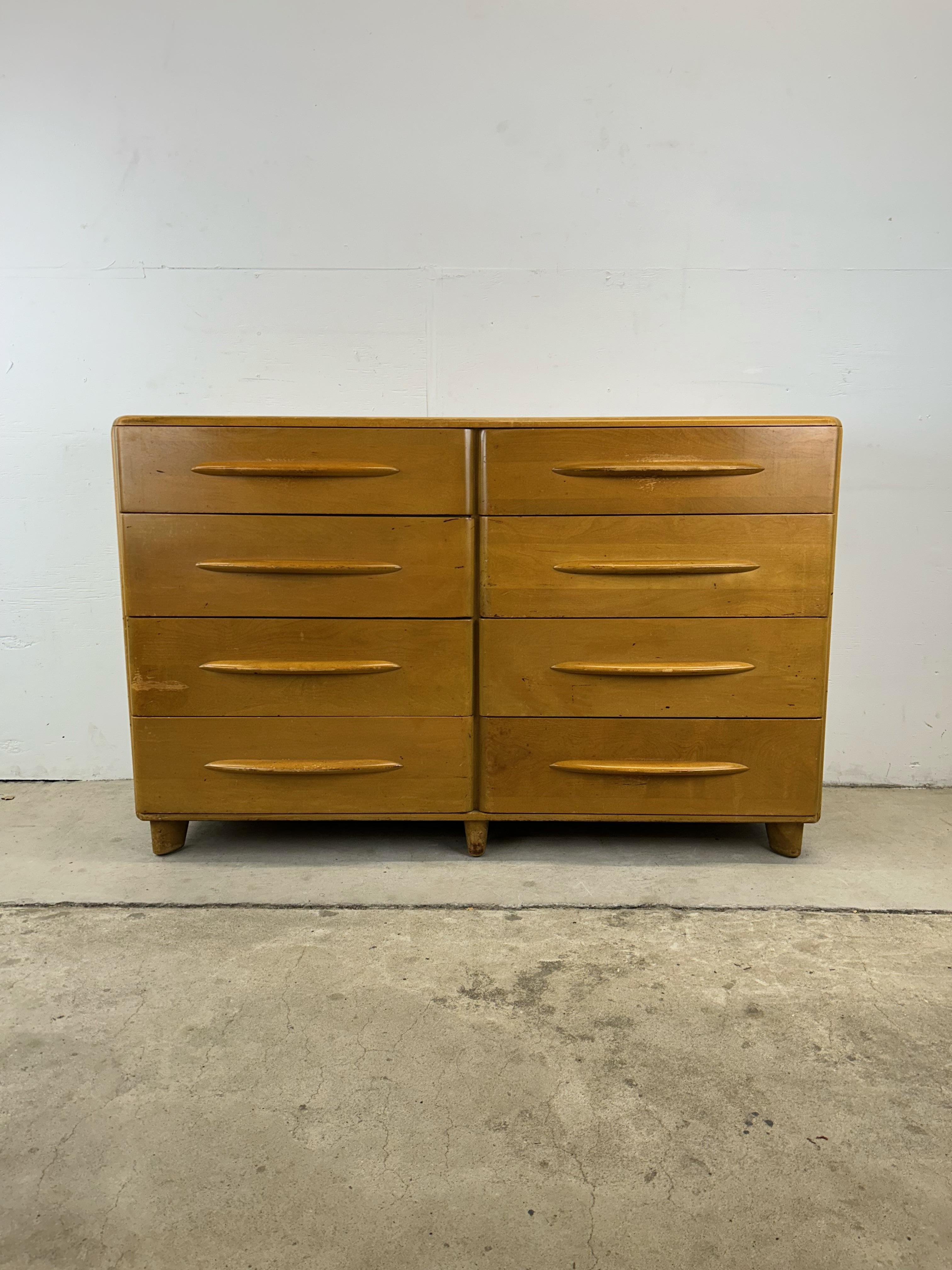 This mid century modern lowboy dresser in the style of Heywood Wakefield features solid maple construction, original champagne finish, eight drawers with carved wood pulls, and unique tapered legs.

Dimensions: 54w 20.5d 34h

Original finish is in