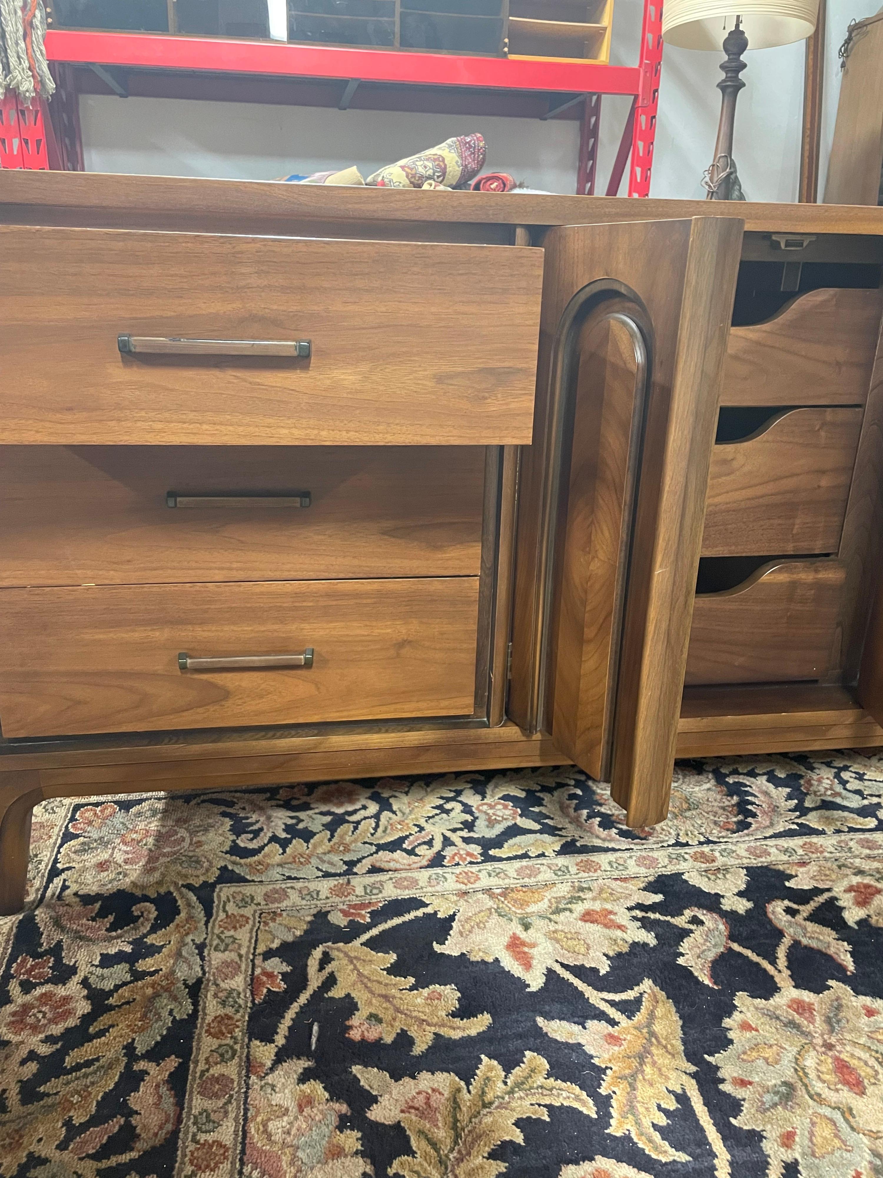 Vintage Mid-Century Modern 9-drawer walnut dresser, believed to be made by Dixie Furniture.