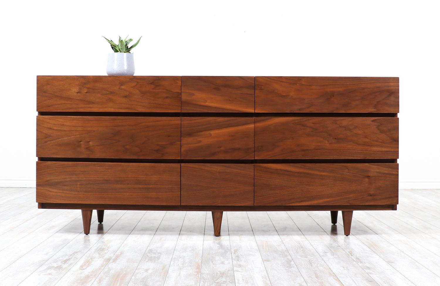 Mid-Century Modern 9-drawer walnut dresser by American of Martinsville.