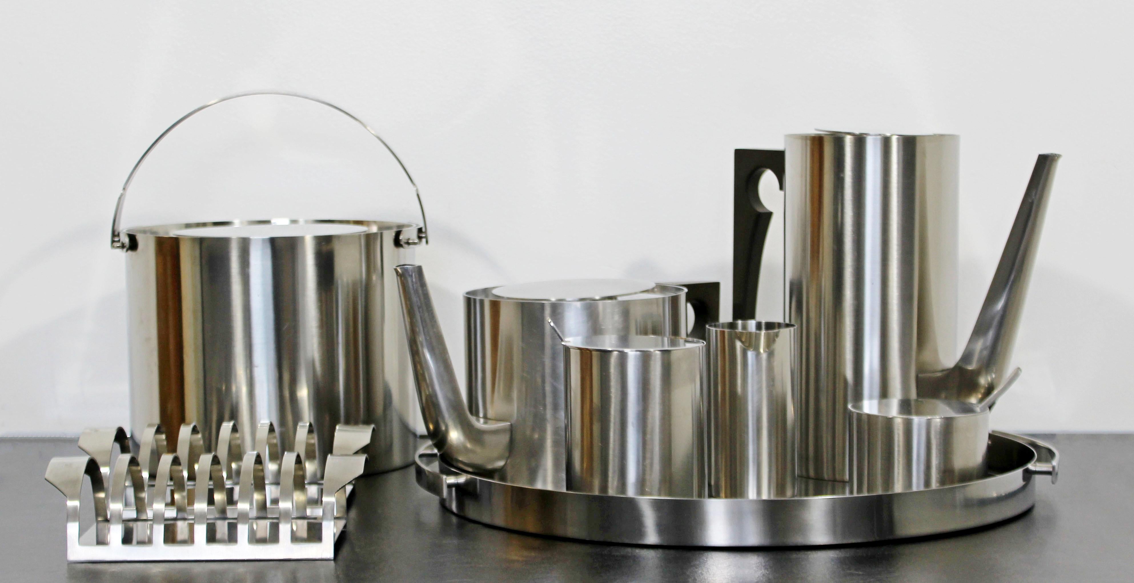 For your consideration is a nine piece, stainless steel tea and coffee service set, made in Denmark, by Arne Jacobsen for Stelton's Cylinda Line, circa 1970s. Set includes an ice bucket, a tea kettle, a tall caraf, a serving tray, a sugar caster