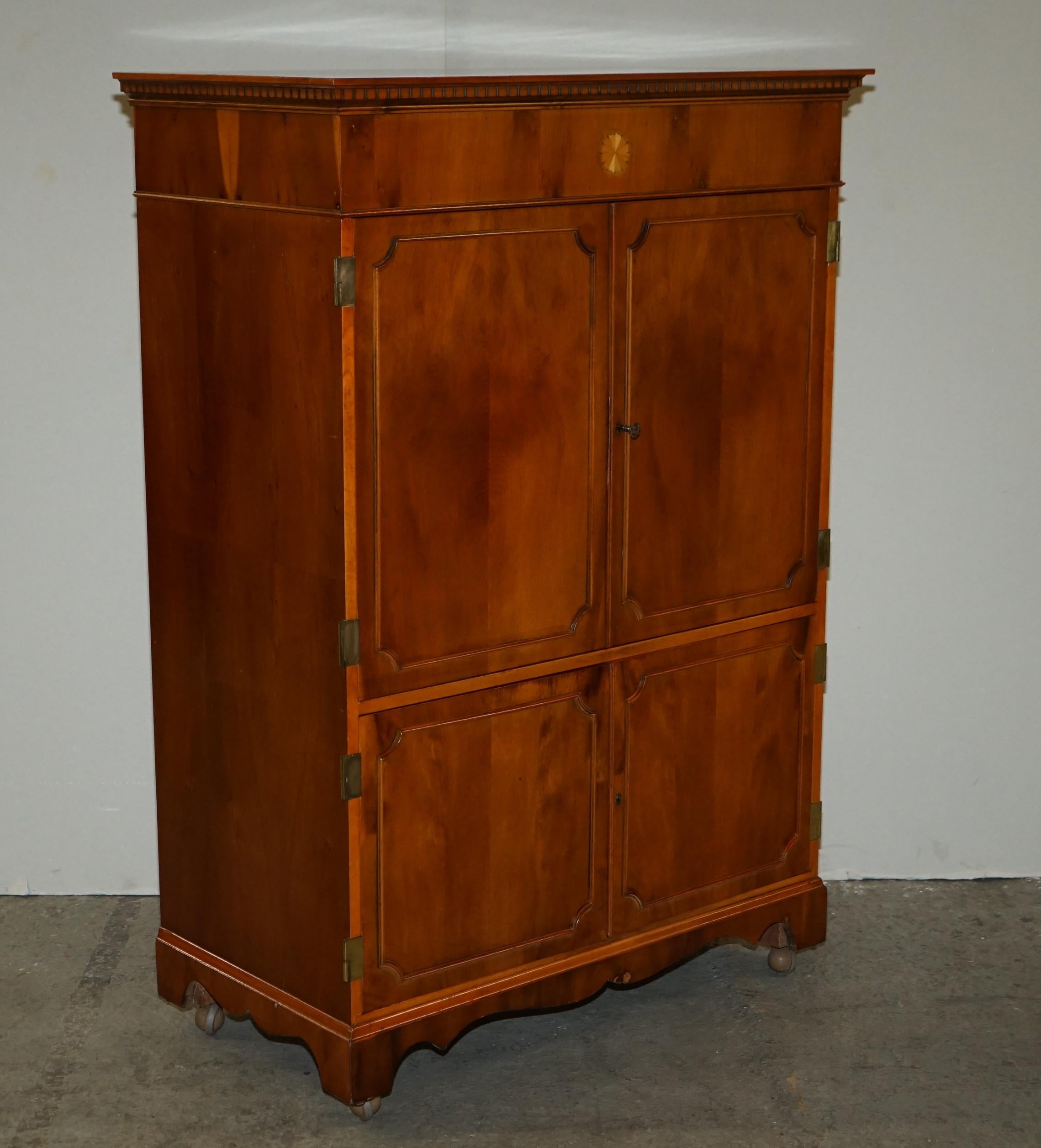 Here we have for sale this Mid-Century Modern Abbey Craft yew wood tv media cabinet with hinged top and Sheraton detailing.

Overall, the cabinet is in good condition with a few signs of wear, it looks like the back section has been removed and