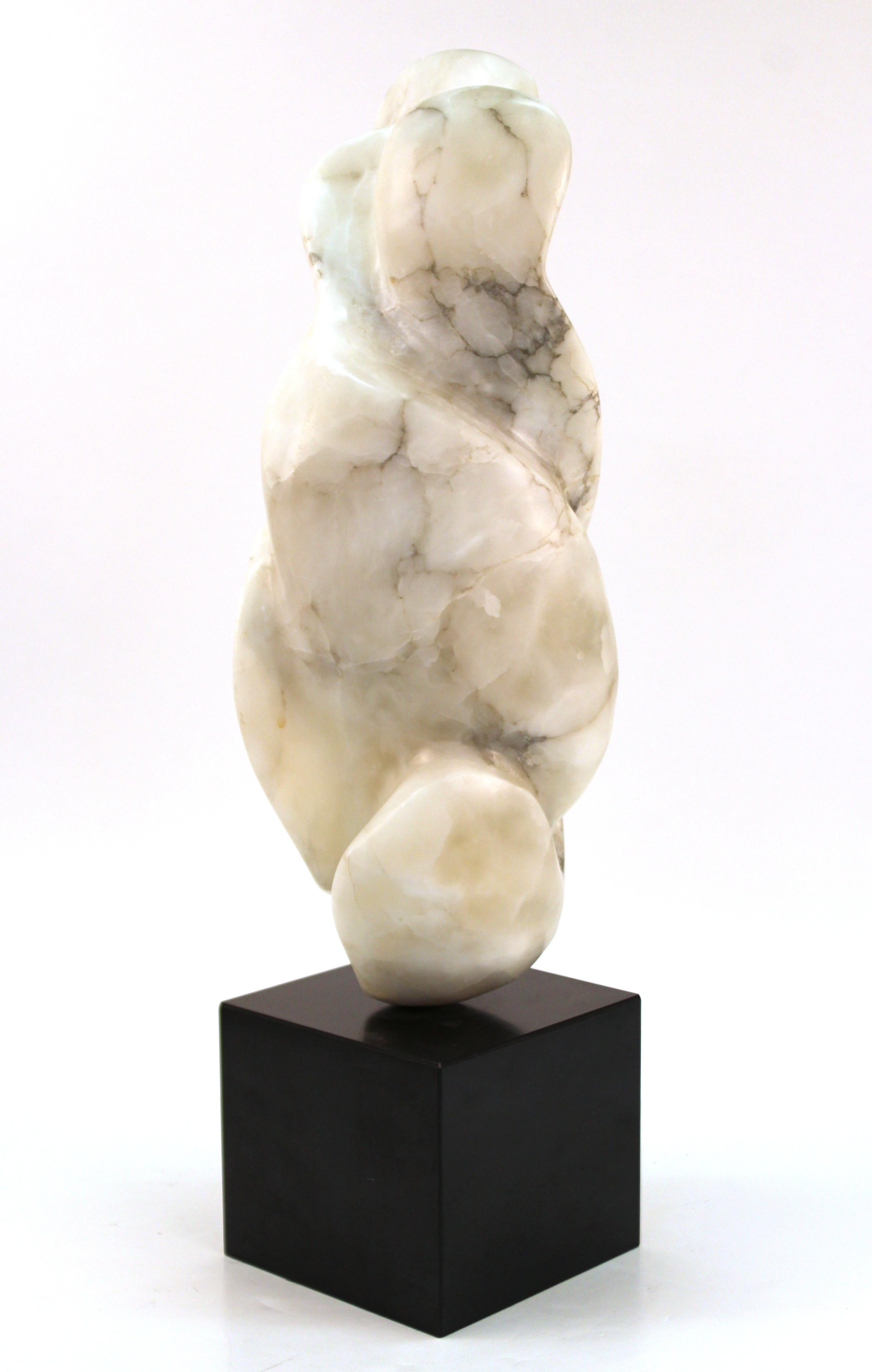 Mid-Century Modern abstract biomorphic marble sculpture, signed Levner. The piece is carved in off-white veined marble and is mounted on a square black base. Signed by the artist 'Levner' and dated 1974 on the lower edge of the sculpture. In great