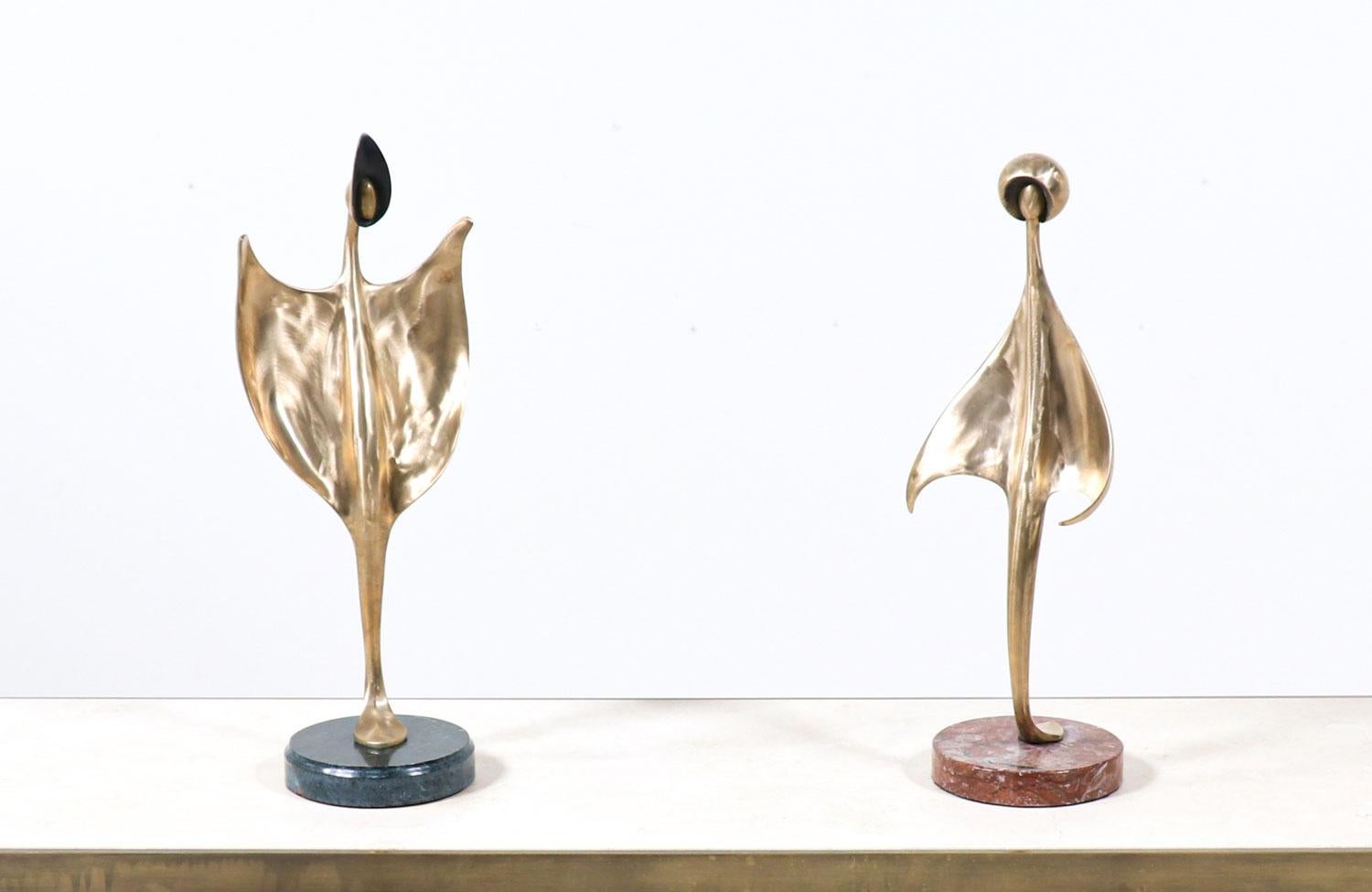 Mid-Century Modern abstract brass sculpture with pink marble base.

 
