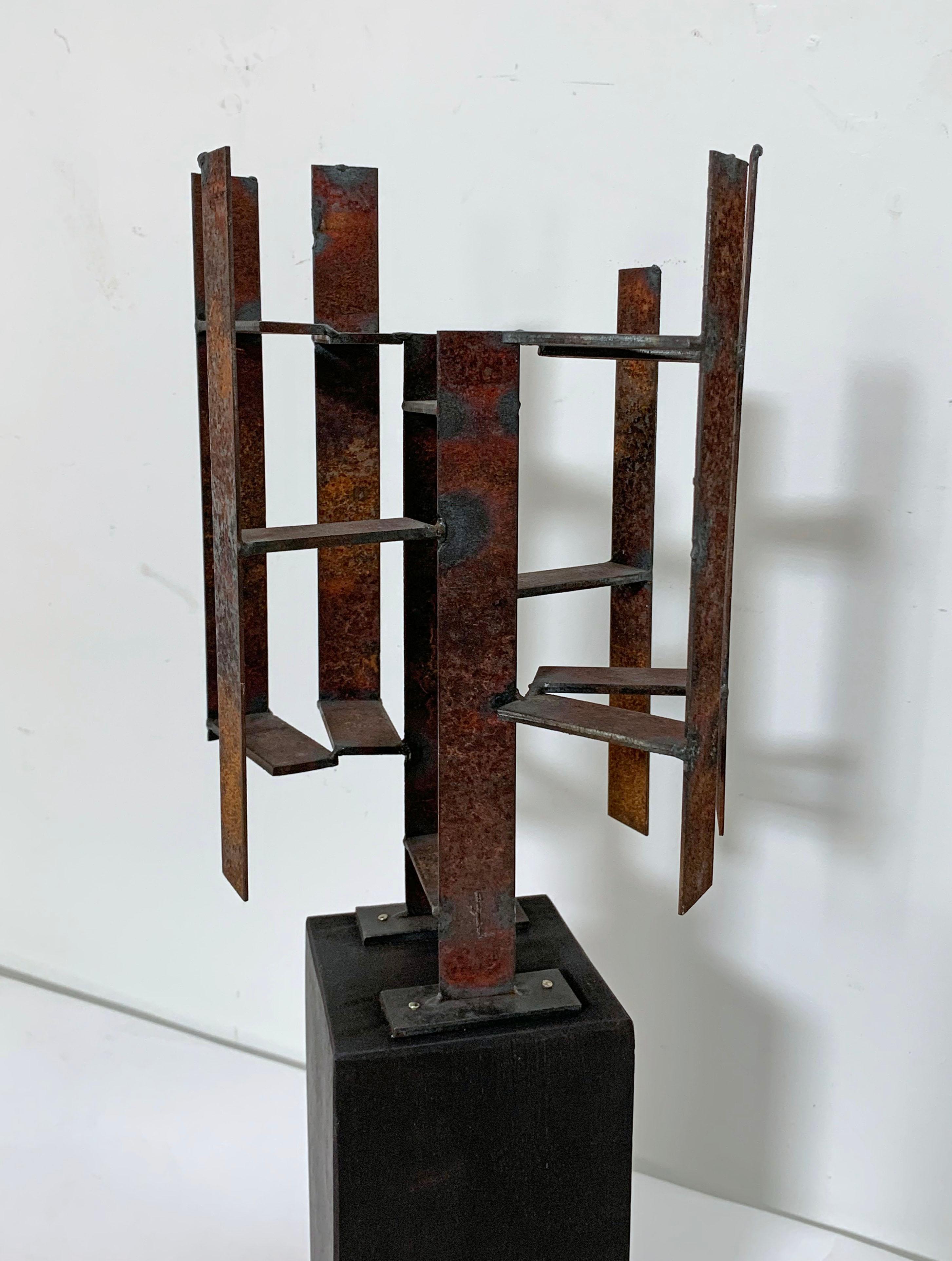 Vintage welded steel sculpture by Acton, MA artist, John Livermore, circa 1970s. Abstract architectural form on mahogany pedestal. Sculpture measures: 7” wide, 6.5” x 10.75” high, without base. The base is 8” high.