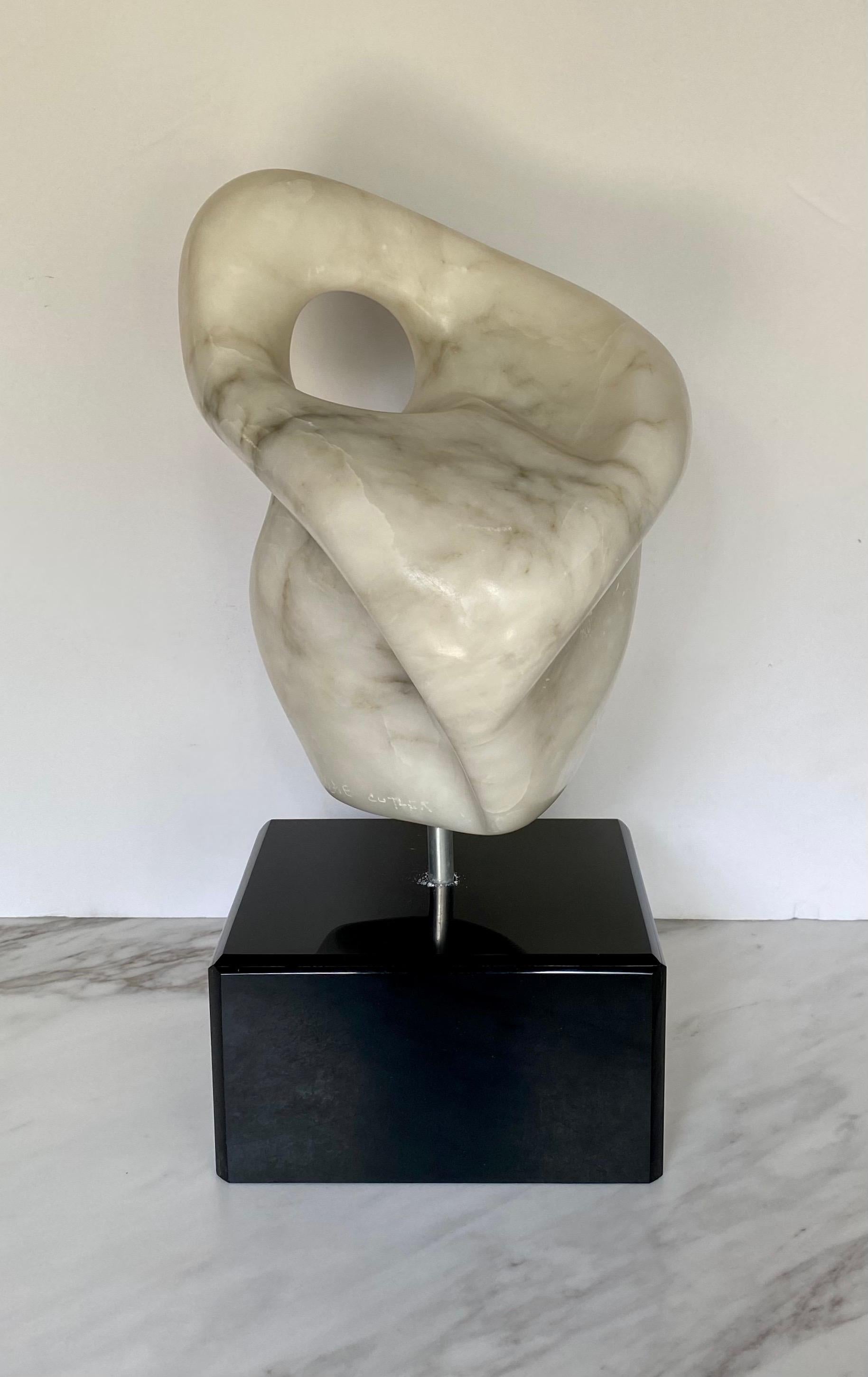 Mid-Century Modern free-form abstract table top sculpture entitled 'Prelude' by M. Cutler. This pivoting marble biomorphic sculpture is mounted on a black lacquered plinth base. Signed by artist M. Cutler. 

Base: 5