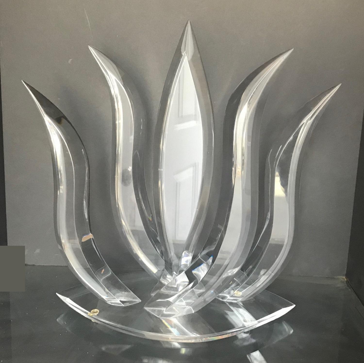 This glowing Mid-Century Modern Lucite sculpture is wonderfully reflective and may appear in cool light as ice or in warm, as fire. The pointed ends reach outward in a balanced abstract design. It is an appealing piece from all angles that makes a