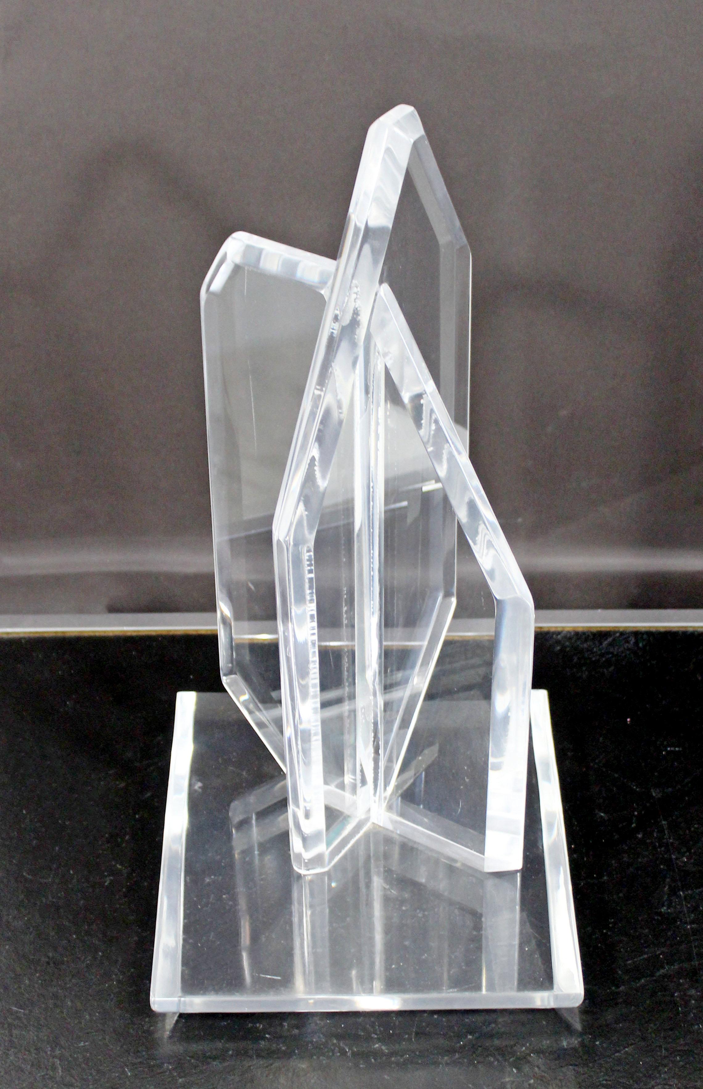 For your consideration is a wonderful, abstract table sculpture, made of clear Lucite, circa the 1970s. In very good condition, except for a mark in one of the corners. The dimensions are 9