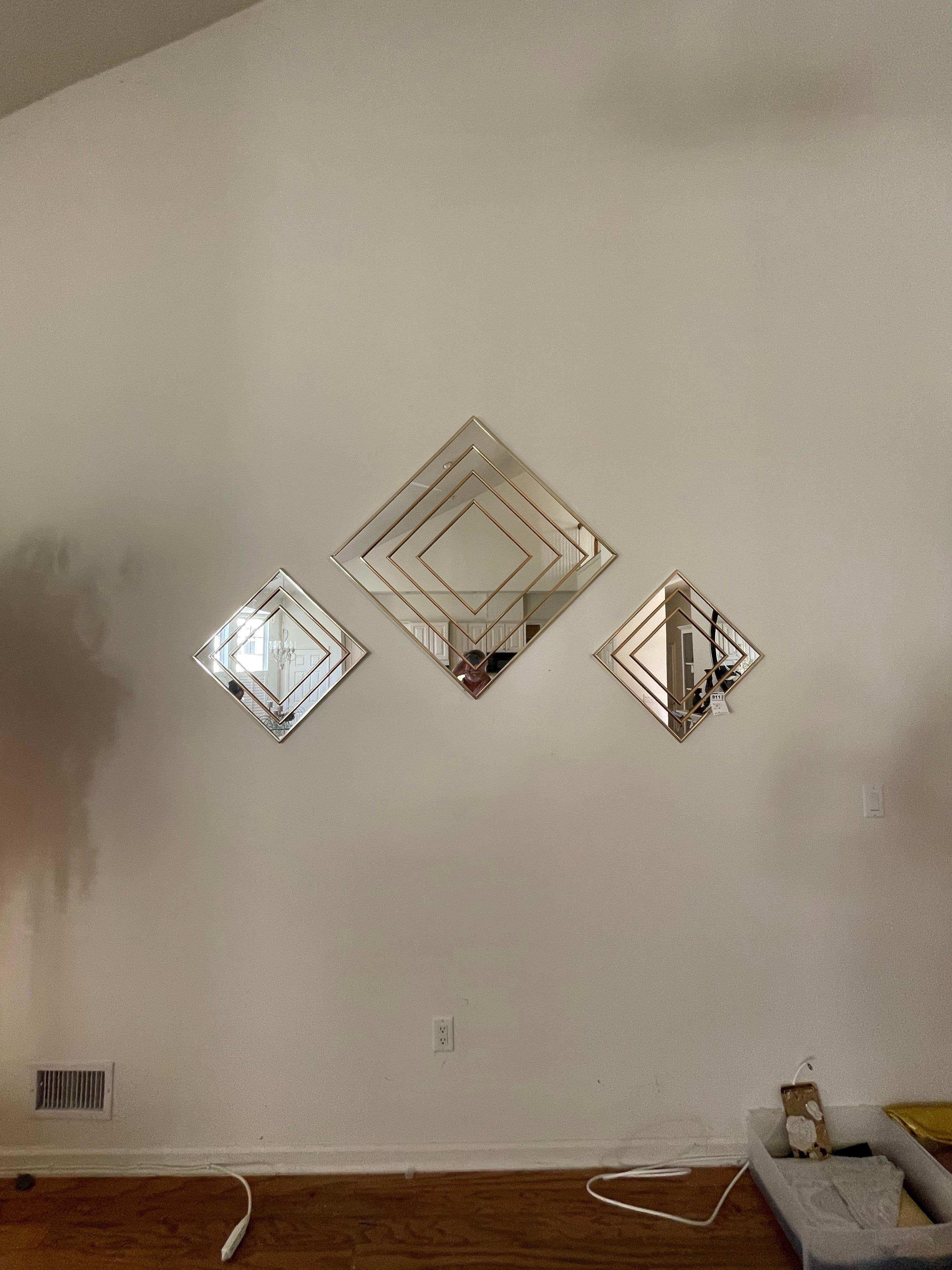 A chic post modern style gold mirror grouping by Sharon Art Concept. Center mirror is 30