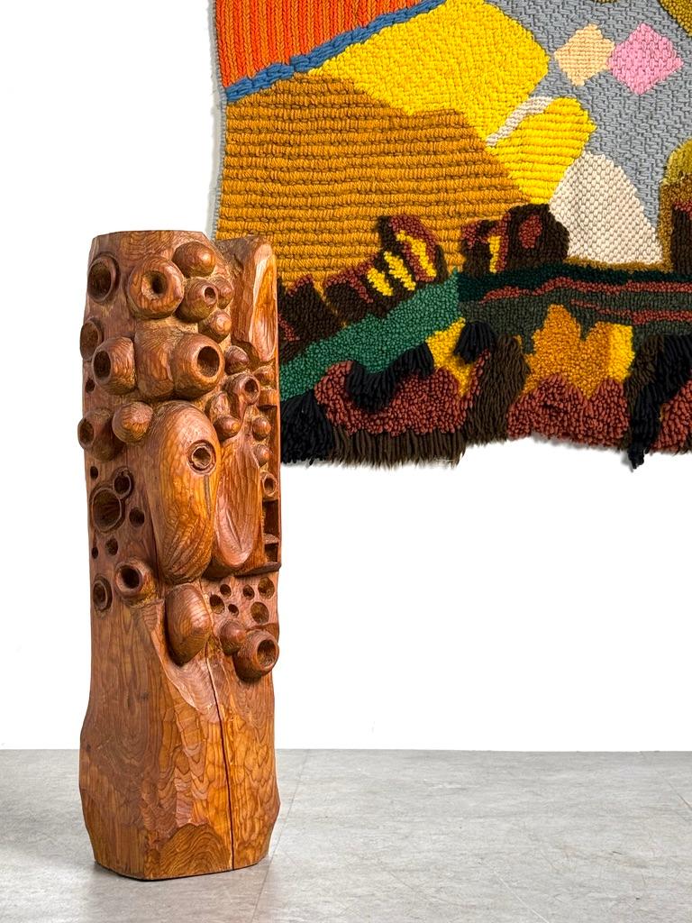 Large hand carved abstract wood sculpture by Oliver De France 
Circa 1960s

Carved from a single block of richly grained pine with a dimensional interplay of biomorphic forms and clustered voids

The base and reverse remain rough hewn, emphasizing