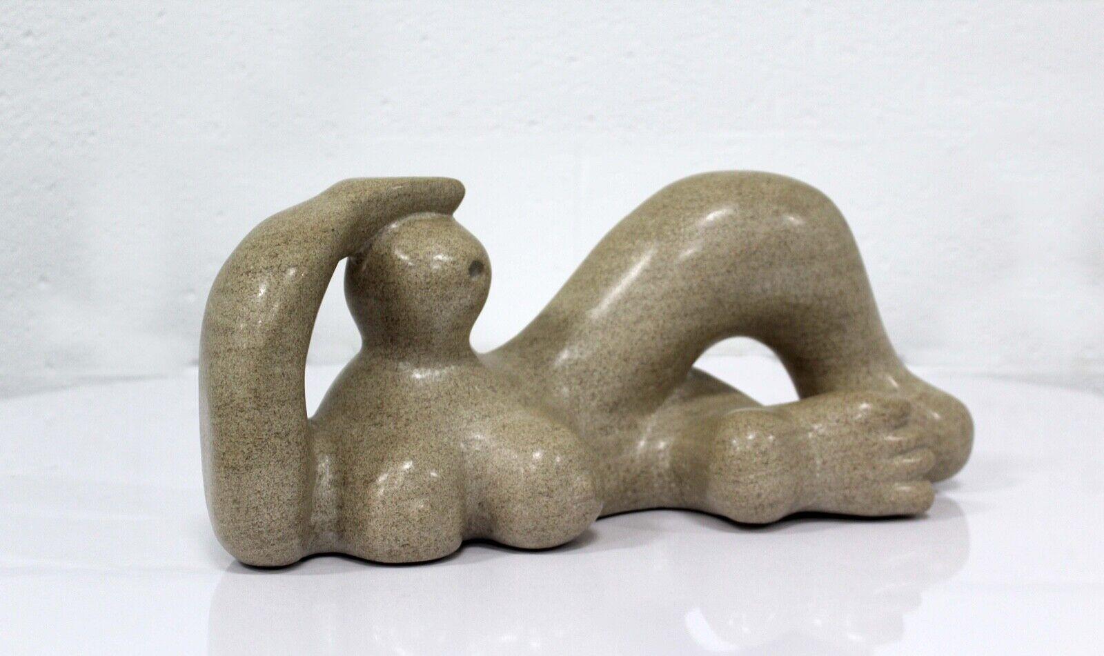 Le Shoppe Too in Michigan is offering a modernistic reclining figure stone sculpture. The curving semi-abstract figure is in the style of Henry Moore. Sculpture is unsigned. Dimensions: 16