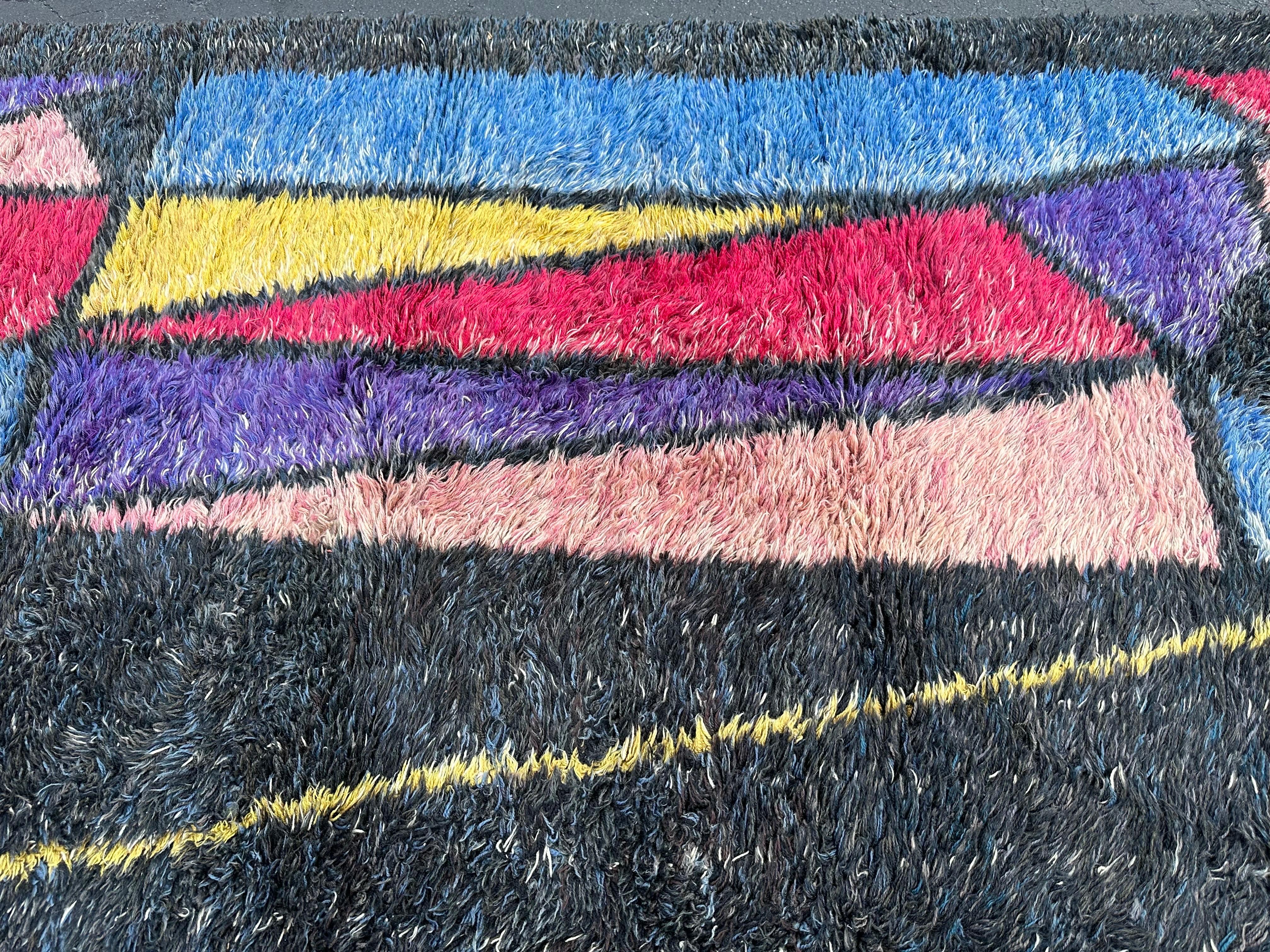 This vintage mid-century modern rug is a true gem for collectors and enthusiasts alike. Made in Denmark in the 1960s-70s, it features a beautiful abstract shag design that is sure to add a touch of vintage charm to any space. The rug is perfect for