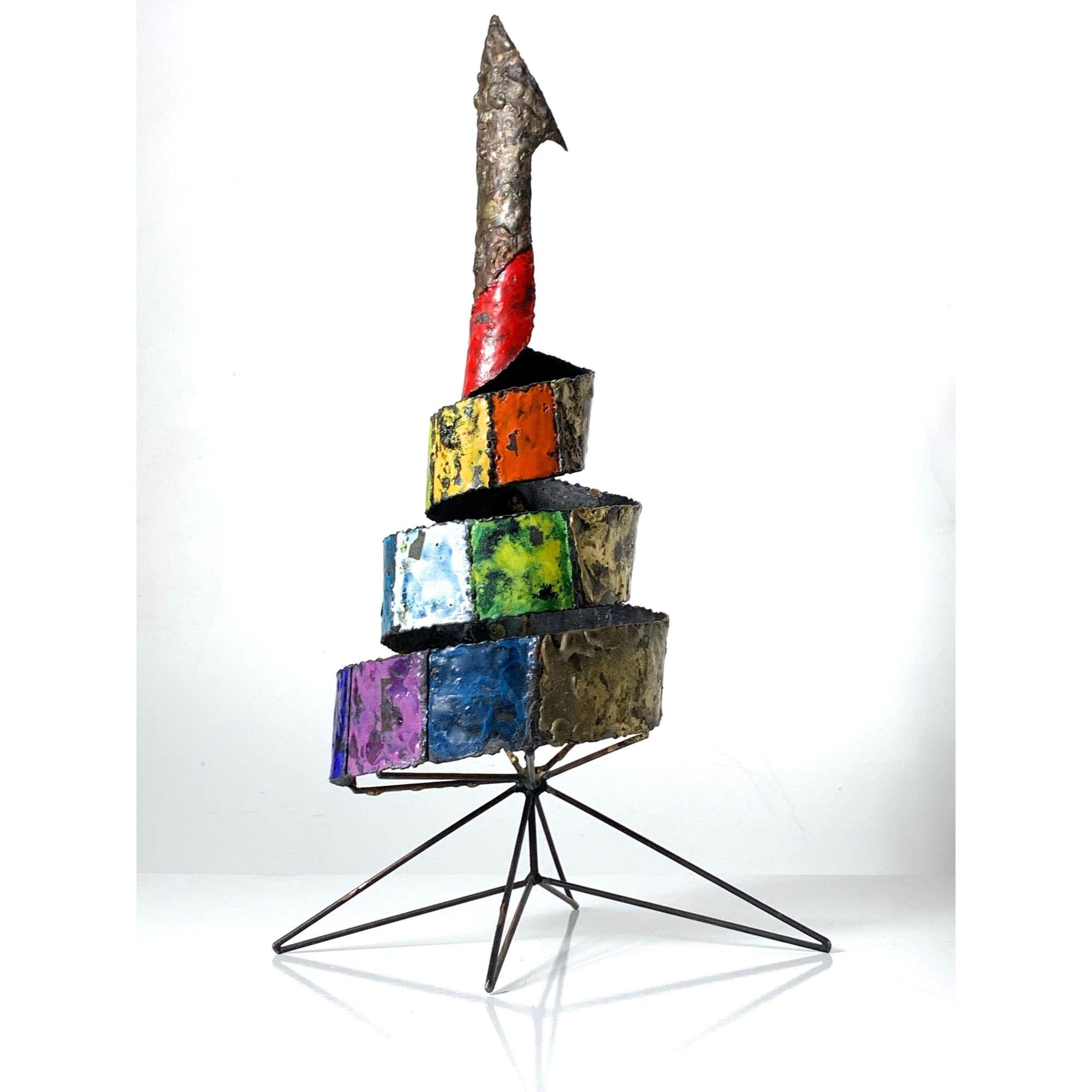 Vintage Abstract Enamel Metal Sculpture 1960s

Unique abstract metal sculpture circa 1960s. 
Spiral ribbon form with colorful blocks of applied enamel and melt coat brass on iron hairpin base.
Unsigned.

Additional Information:
Materials: Brass and