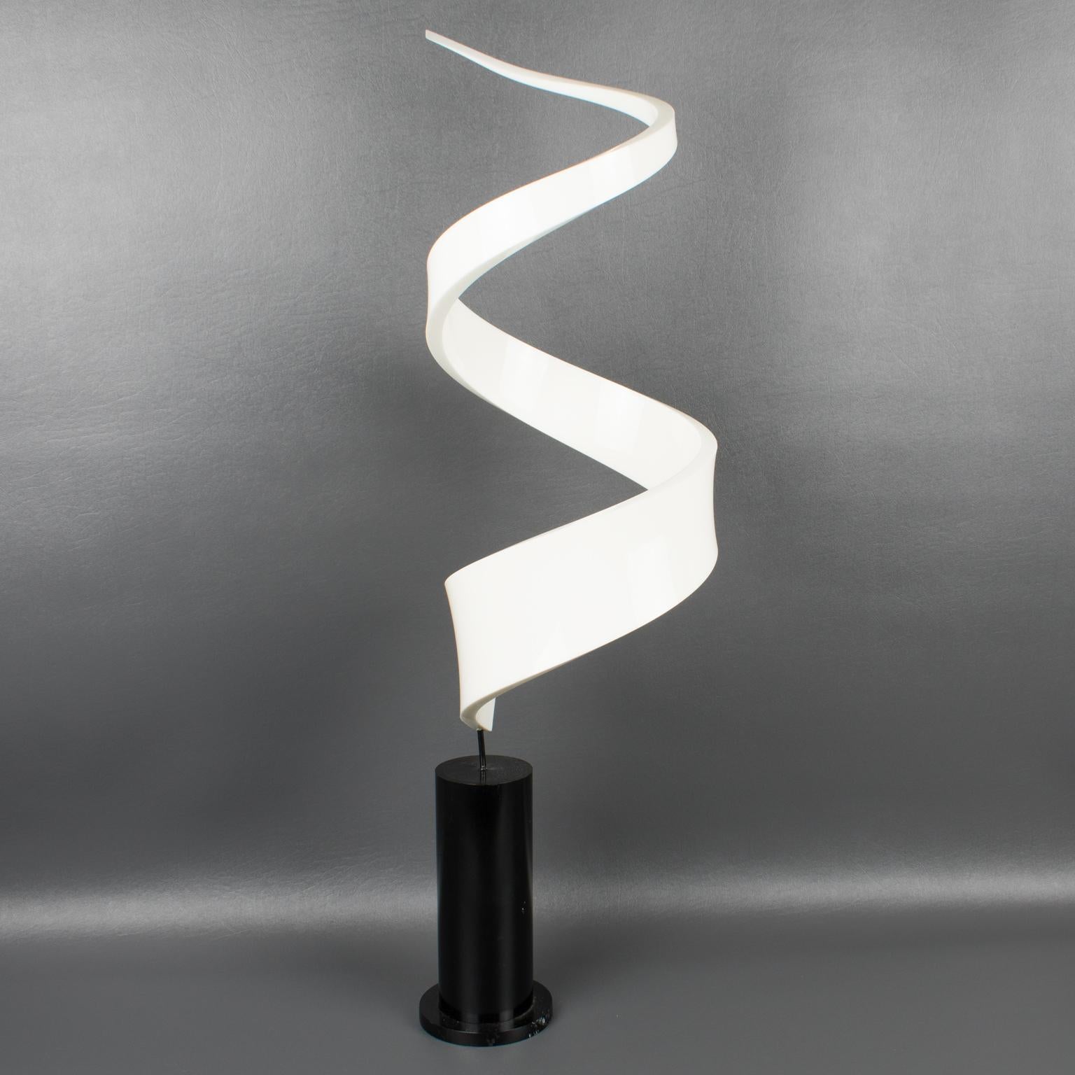 Stunning 1970s Lucite or Plexiglass sculpture. Abstract geometrical swirl shape, with milky white color mounted on a tall stepped black Lucite or acrylic base. Different visual effects on each side. No visible maker's mark.
Measurements: 8.88 in