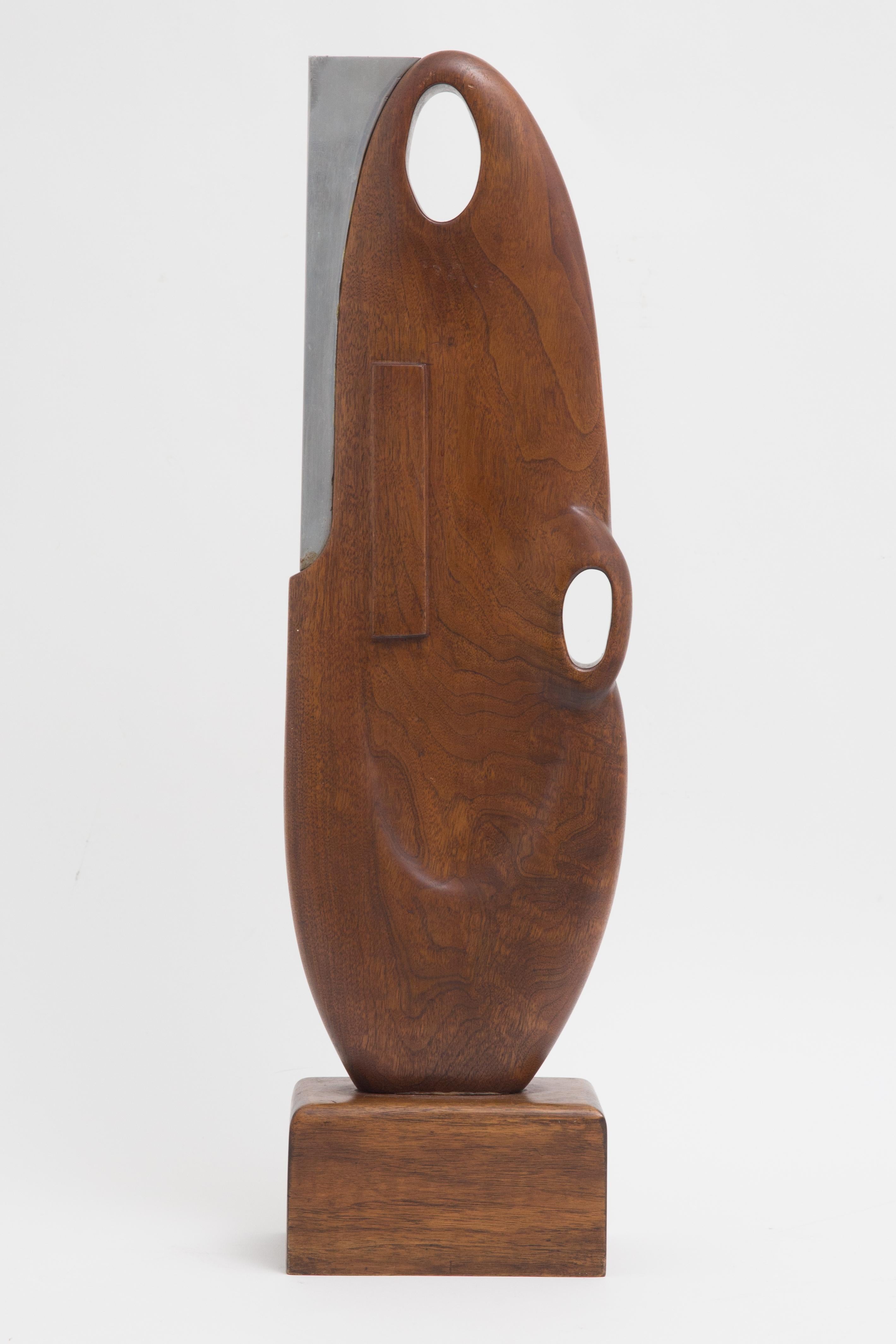 Offered is a Mid-Century Modern abstract wood and aluminum sculpture circa 1950 mounted on a wooden plinth/base. The work stands approximately 27” in height and bears a gallery/exhibition label on the bottom of the mounting. The label has faded and