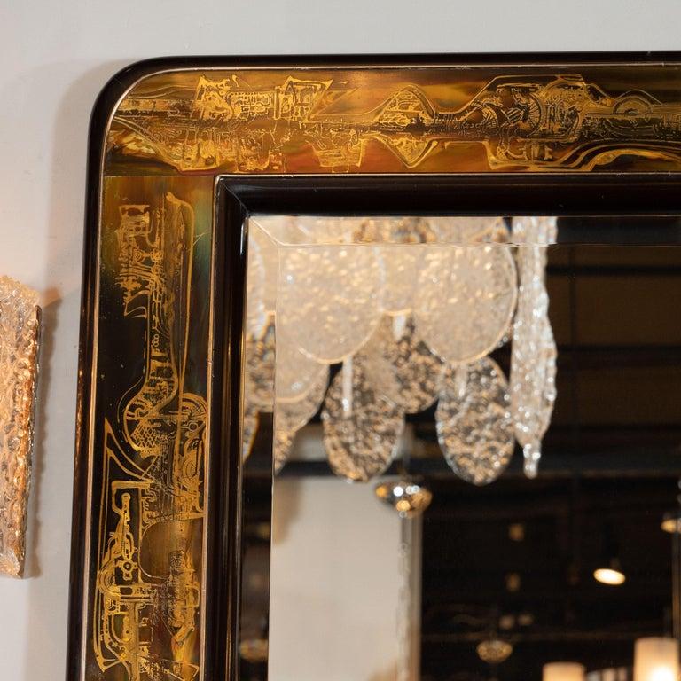 This sophisticated wall mirror designed by Bernard Rohne and realized for the esteemed American maker, Mastercraft, circa 1970. The brass interior of the frame features organic and futuristic acid etched detailing- suggesting the forms of Yves