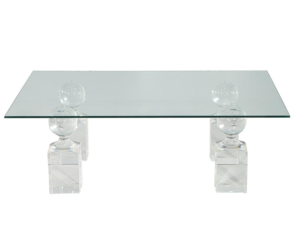 Step into the captivating realm of this mid-century modern acrylic and glass cocktail table, a testament to the enduring elegance of the 1970s. Crafted with meticulous attention to detail in the heart of the United States, this exceptional piece