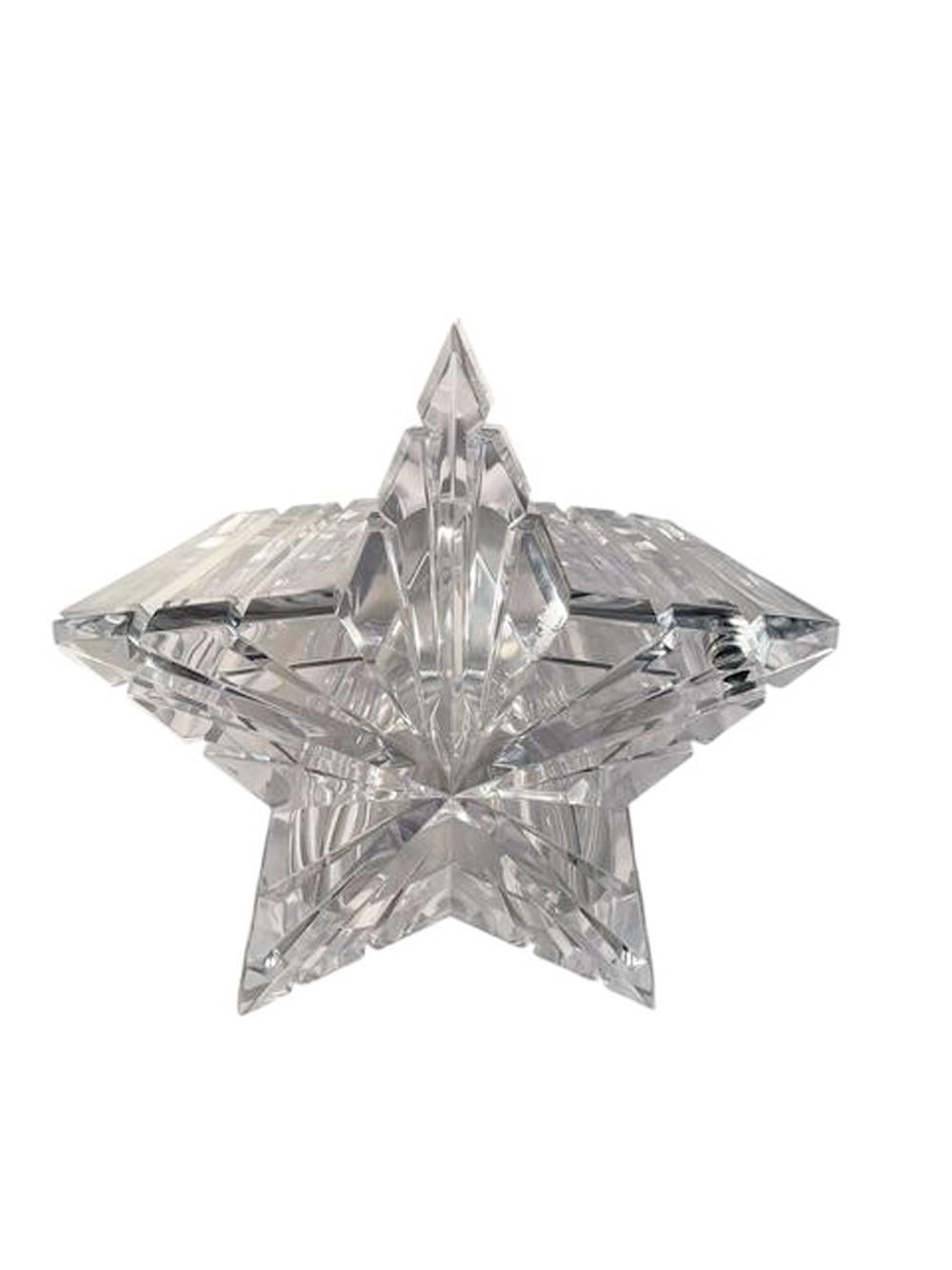 A large clear acrylic ice bucket in the form of a five-pointed star having a conforming swivel lid with a sloped top, The lid cut with 