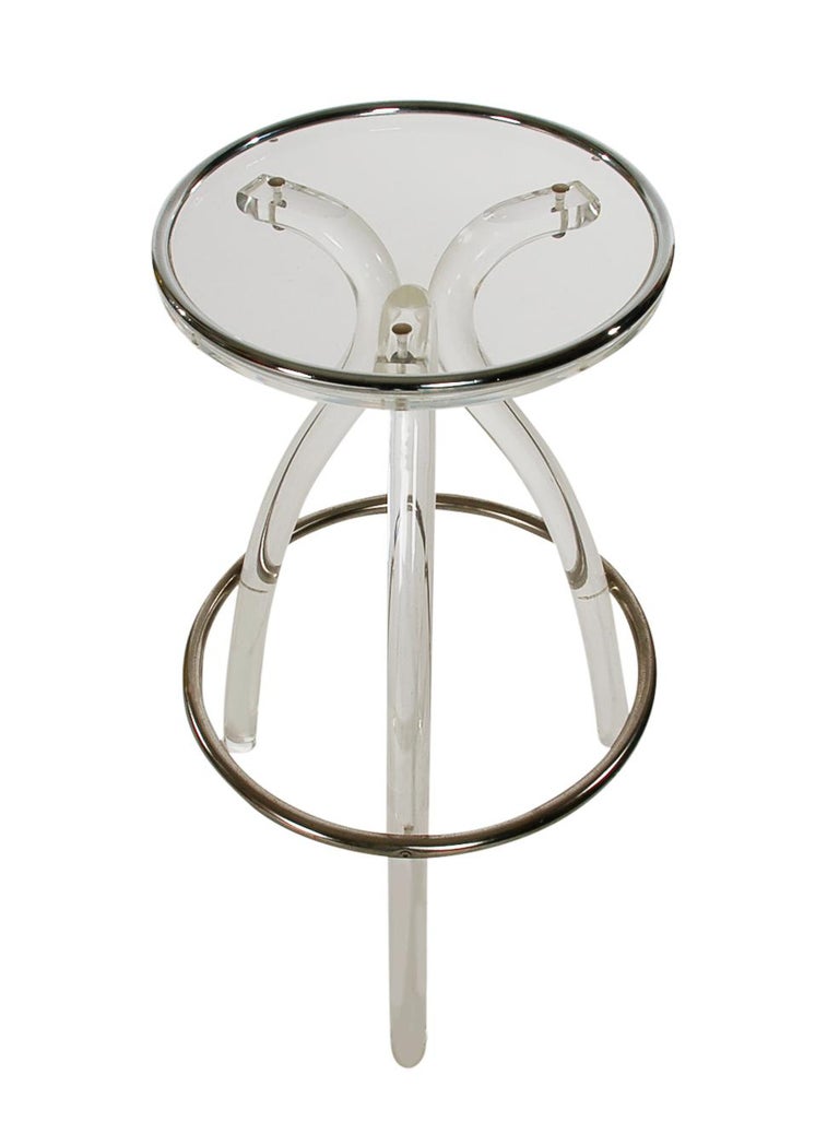 A super modern acrylic bar or counter stool made by Hill Manufacturing. It consists of very thick acrylic legs, crystal clear seat, and polished steel footrest.