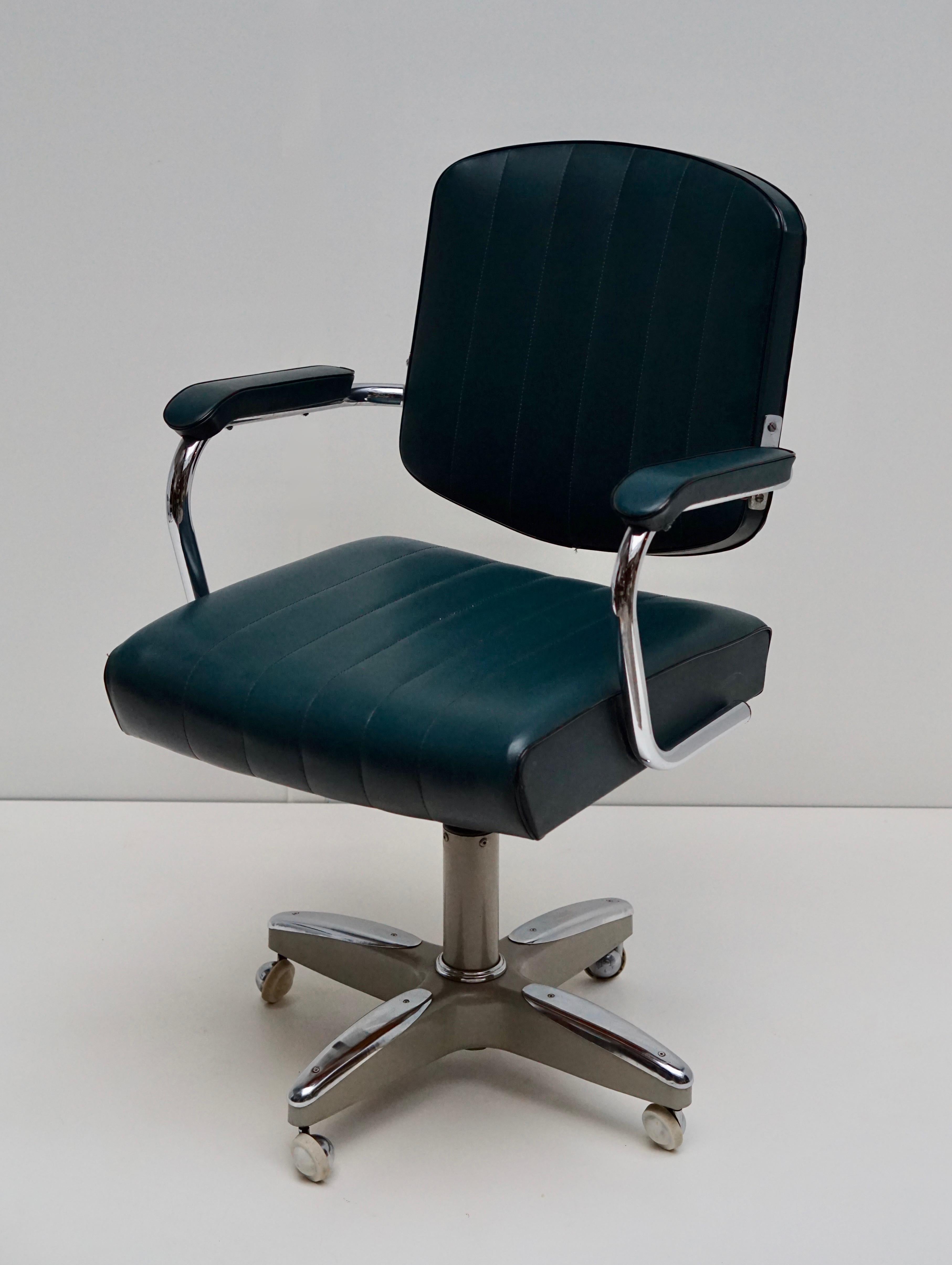 Handsome Mid-Century Modern rolling, swivel, and adjustable desk armchair. It is in fabulous vintage condition and ready to use, circa 1960s.Wow! If you are looking for Mid-Century Modern rolling desk chair for your home office. You found it. And,