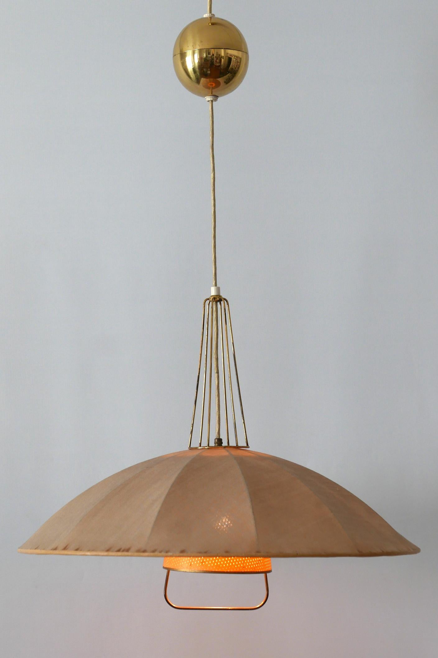 Rare and beautiful Mid-Century Modern counterweight pendant lamp or hanging light. Designed and manufactured probably in 1950s in Germany. Due to the cord egg, the hanging height is easily adjustable.

Executed in brass, metal and fabric, it needs