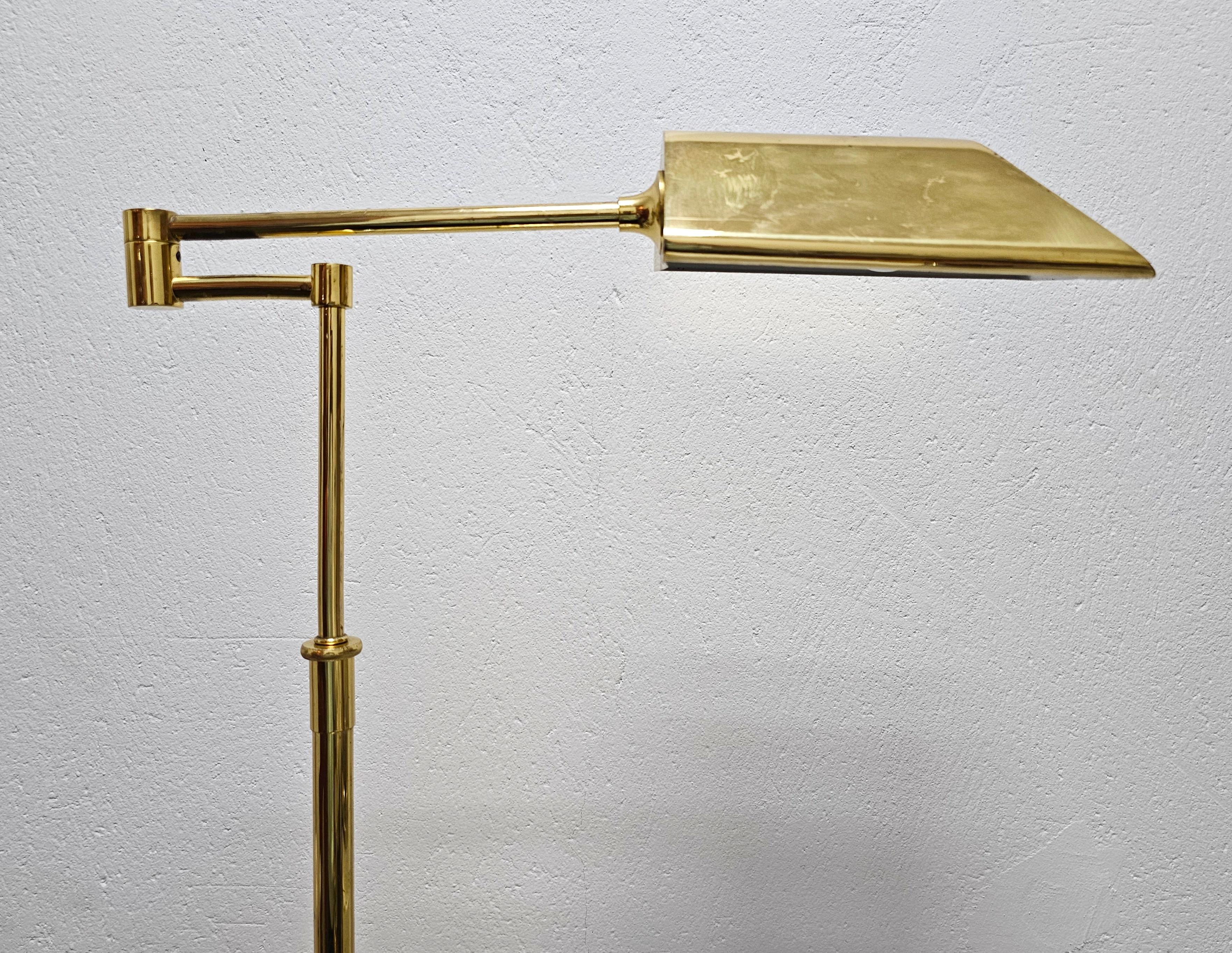In this listing you will find a charming Mid Century Modern Swing Arm floor lamp done entirely in brass. The lamp was manufactured by Fischer Leuchten. It features adjustable height and shade that you can rotate 360 degrees. Made in West Germany in