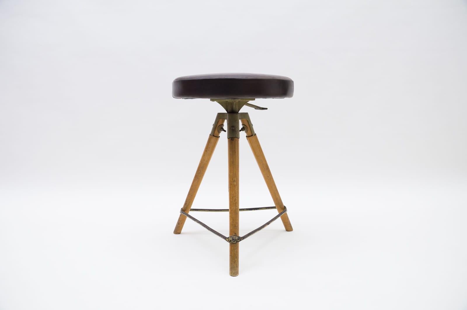 Mid-Century Modern adjustable Swiss stool in leather metal and wood, 1940s/50s.

New upholstery in old neck leather.

Measures: Adjustable from 56cm to 72cm. Seat diameter 39.5cm.

Very decorative, very rare.