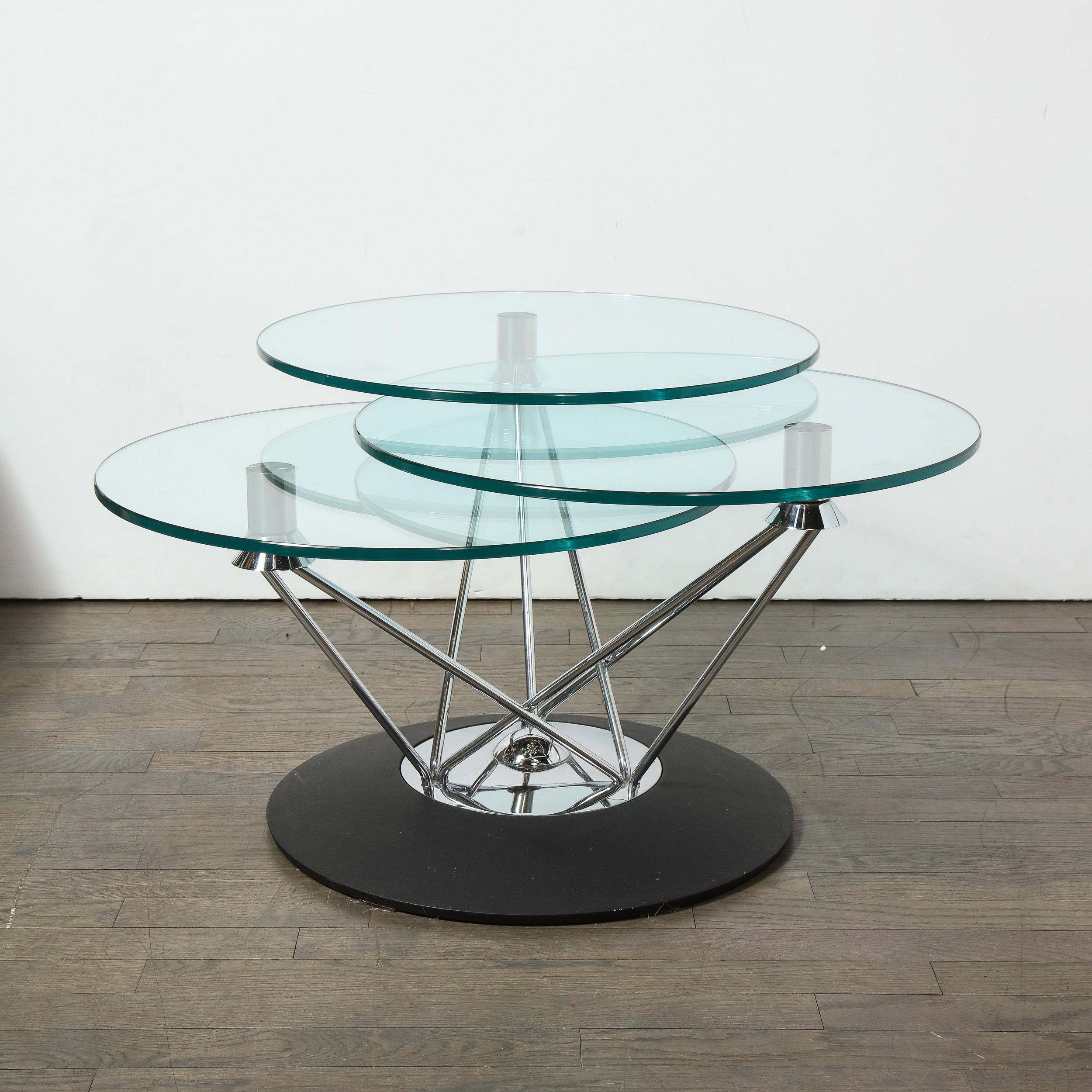 This sculptural and graphic Mid-Century Modern cocktail table was realized in the United States, circa 1970. IT features a gently concave black enamel base capped with a circular polished chrome cap with a finial of the same material emanating from