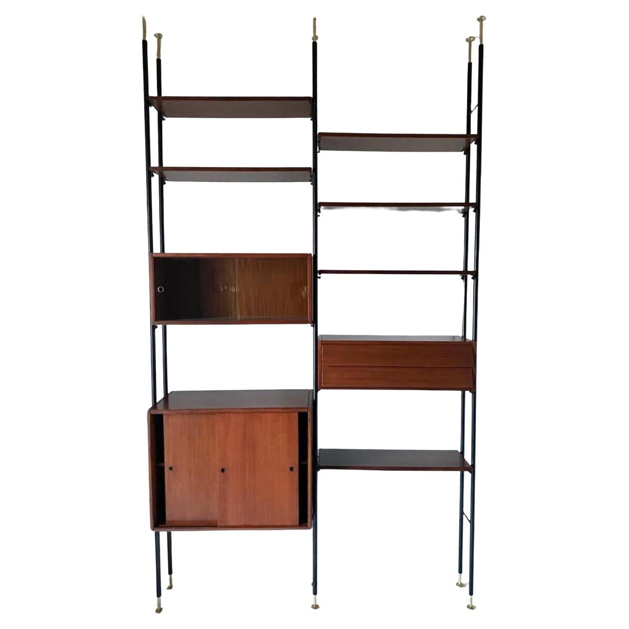 Adjustable Mid Century Modern Wall Unit in scandinavian style manufactured in Italy in the 1960 's.

Dark veneered wood structure made by one sliding doors drawer,  four elengatly refined drawers, a mirroed cupboard and six shelves. Modular