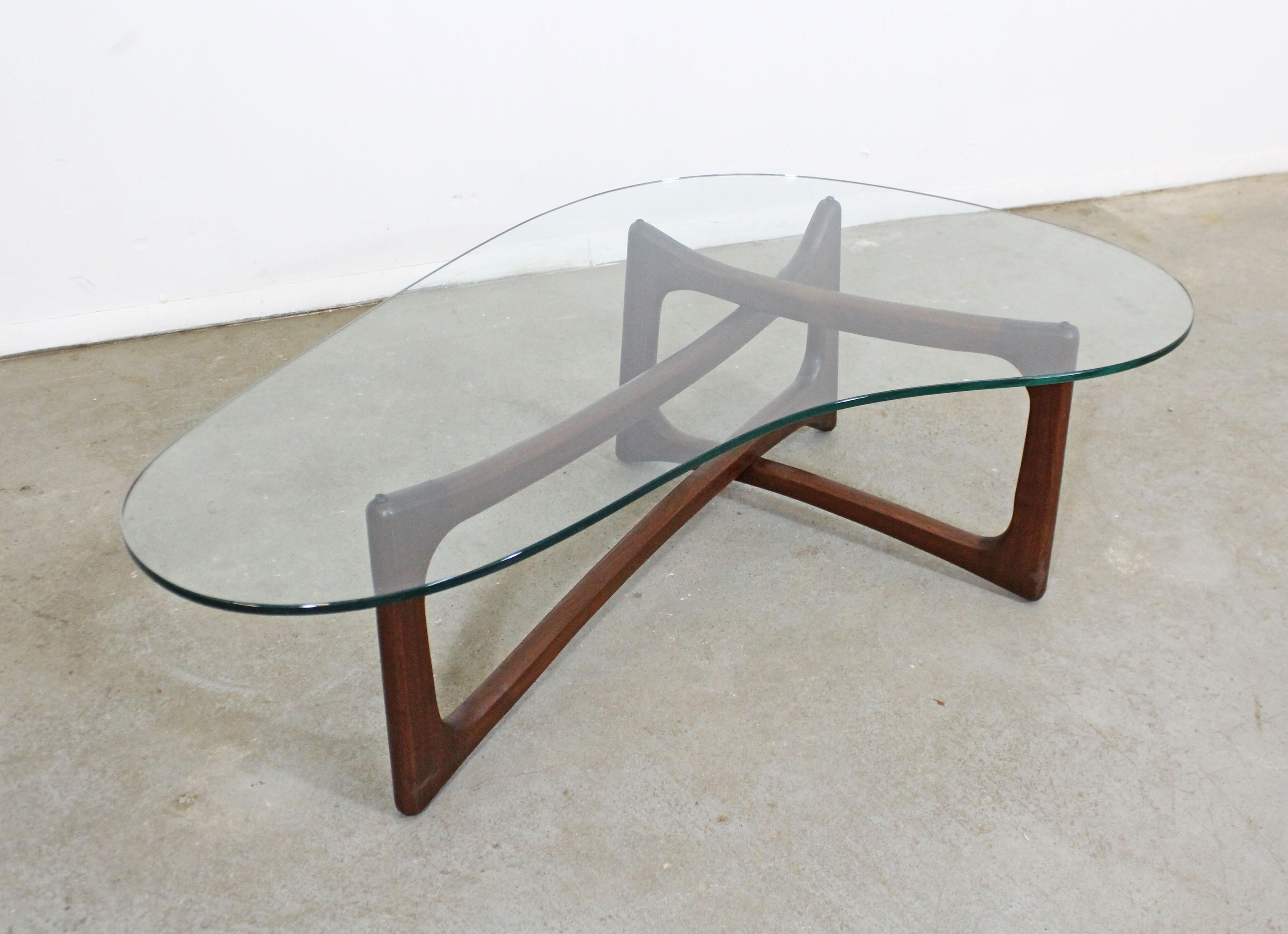 Offered is an authentic Adrian Pearsall coffee table with a gorgeous sculptural wooden base and an amorphous glass top. It was designed by Adrian Pearsall for Craft Associates. It is in good structurally sound condition for its age, shows surface